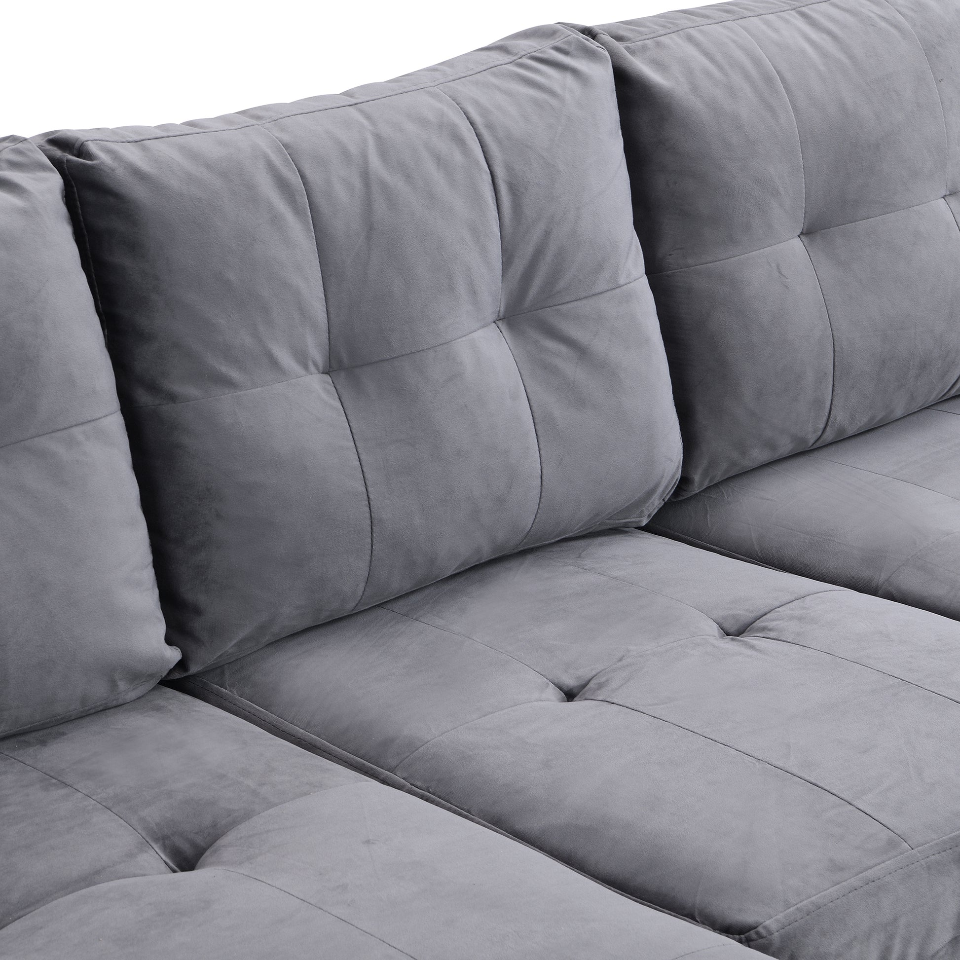 Plush grey velvet sectional sofa with tufted cushions