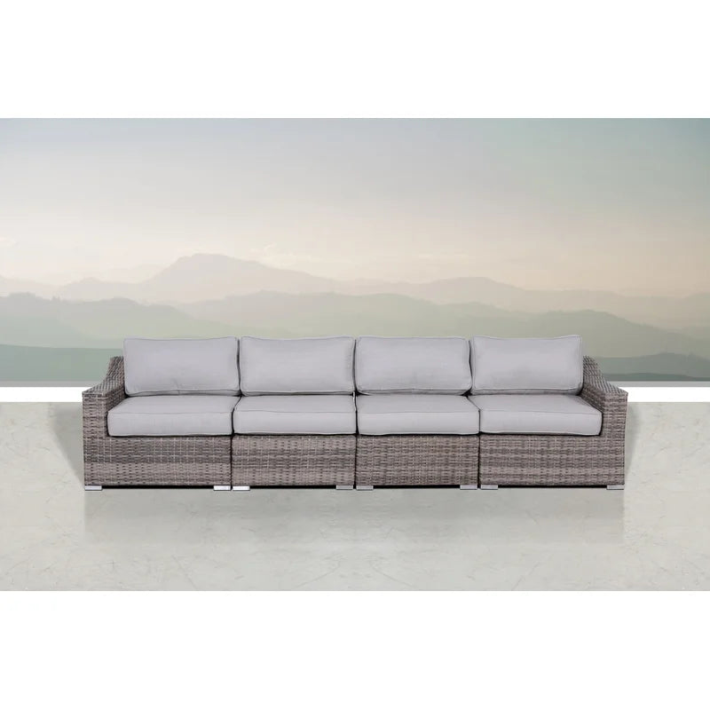 Gray wicker outdoor sectional sofa with plush light gray cushions