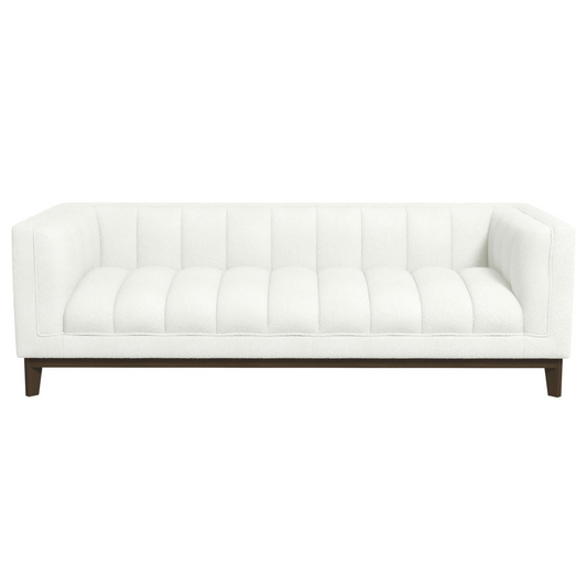White boucle tufted sofa with dark wooden legs