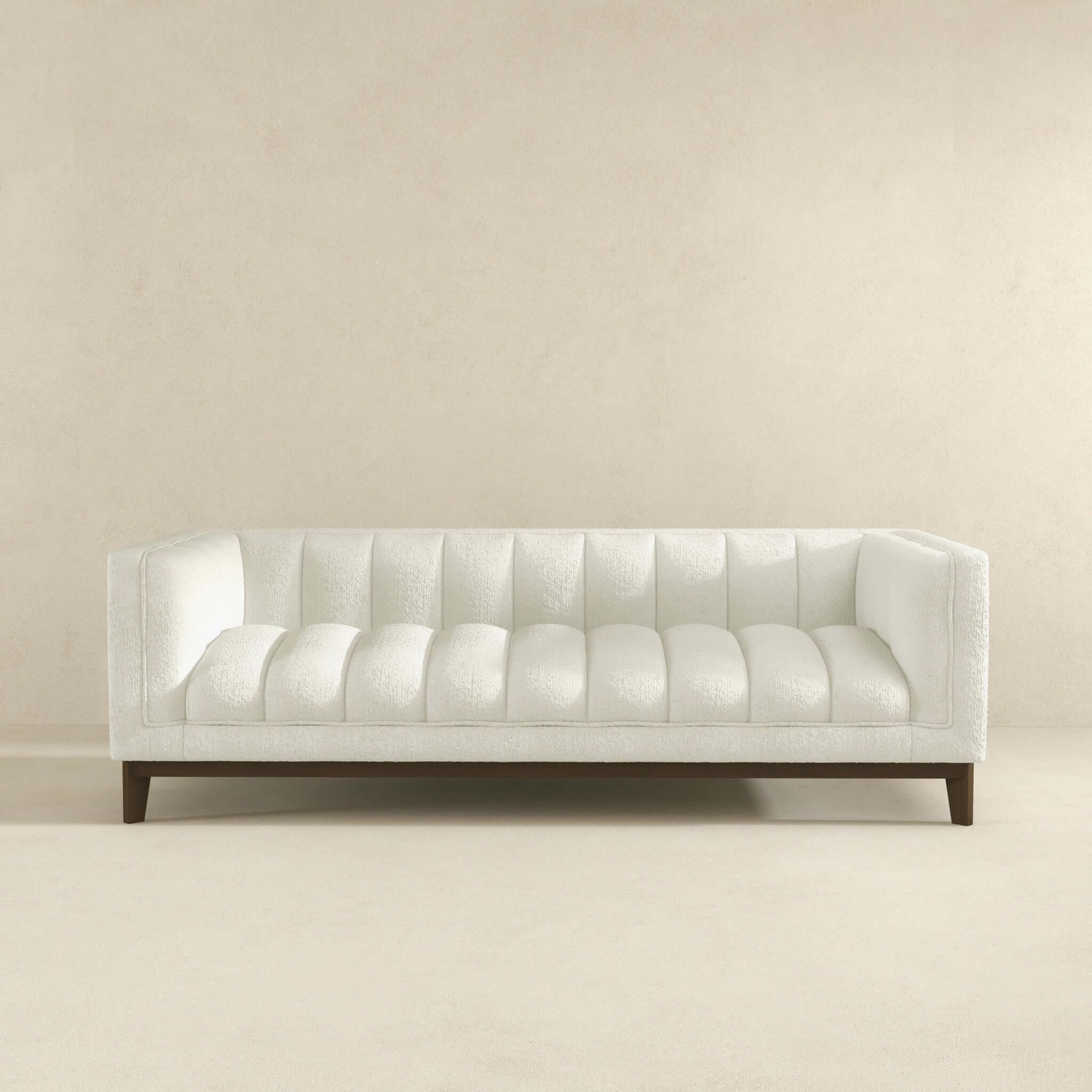 White boucle sofa with channel tufting and dark wood legs