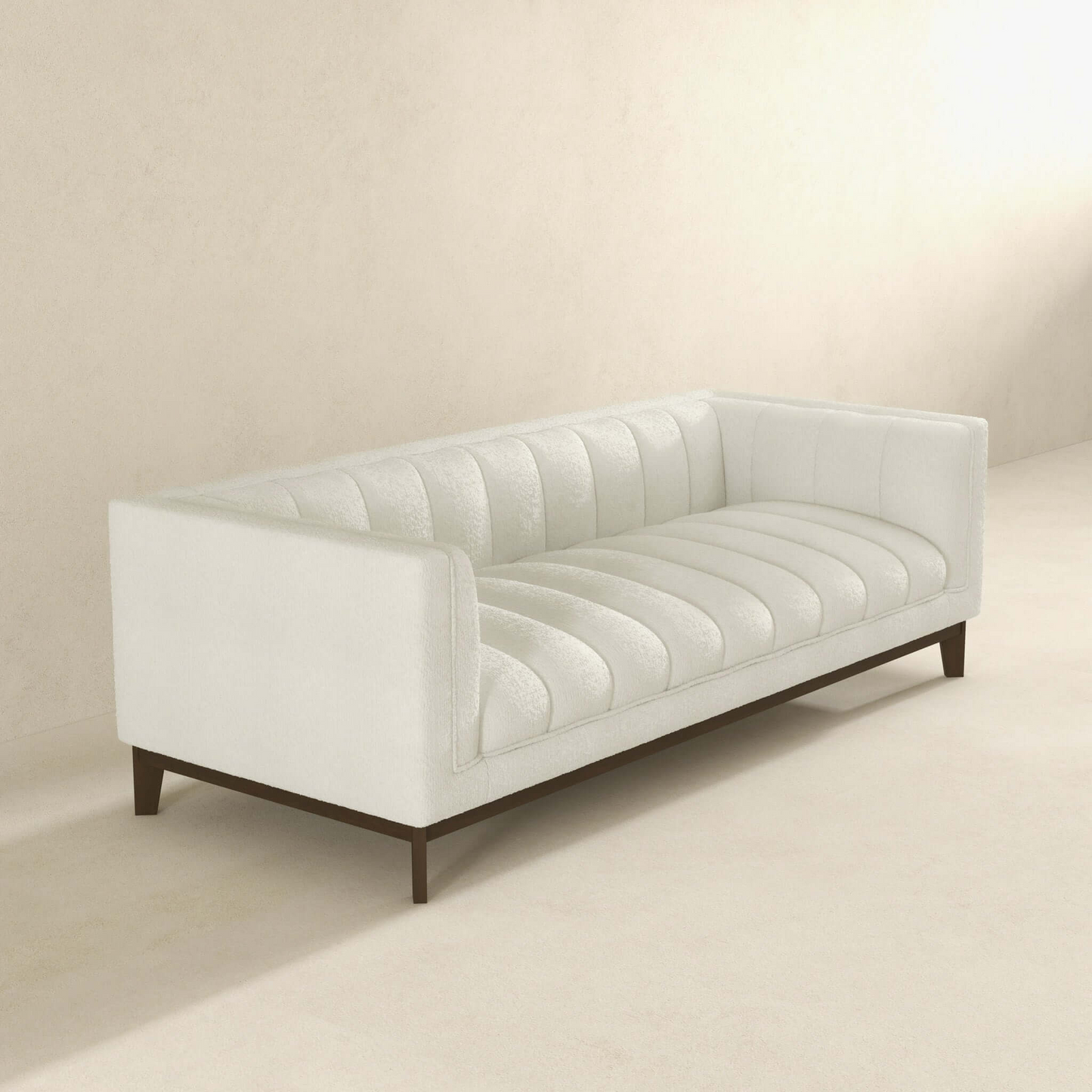 Cream boucle sofa with channel tufting and dark wood legs