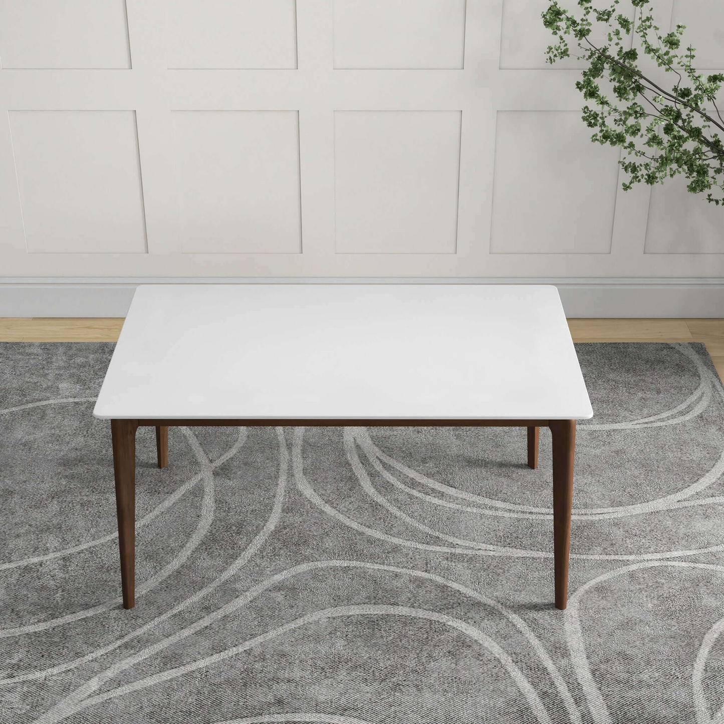 Rectangular white coffee table with tapered wooden legs on a grey patterned rug