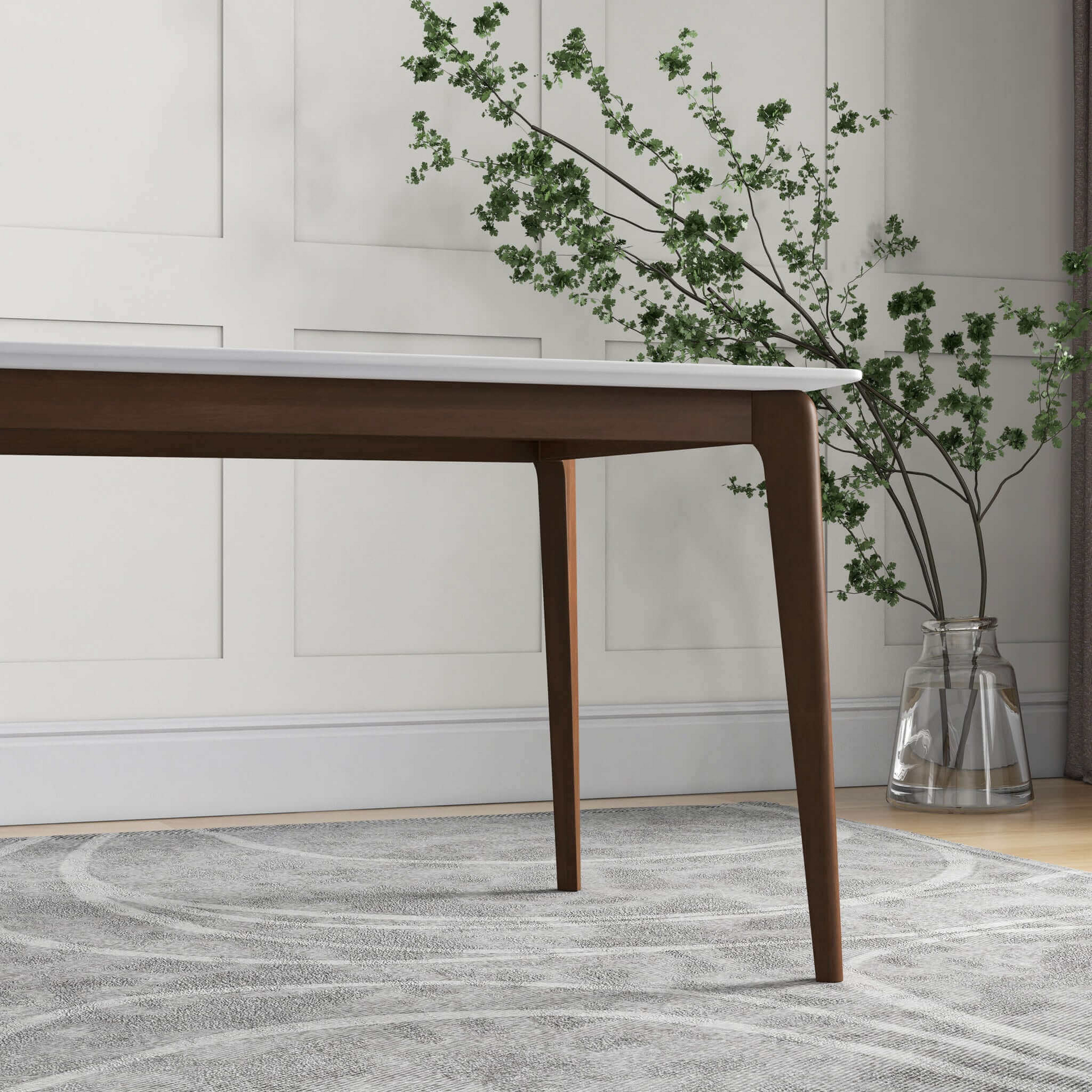Modern dining table with white marble top and dark wood tapered legs