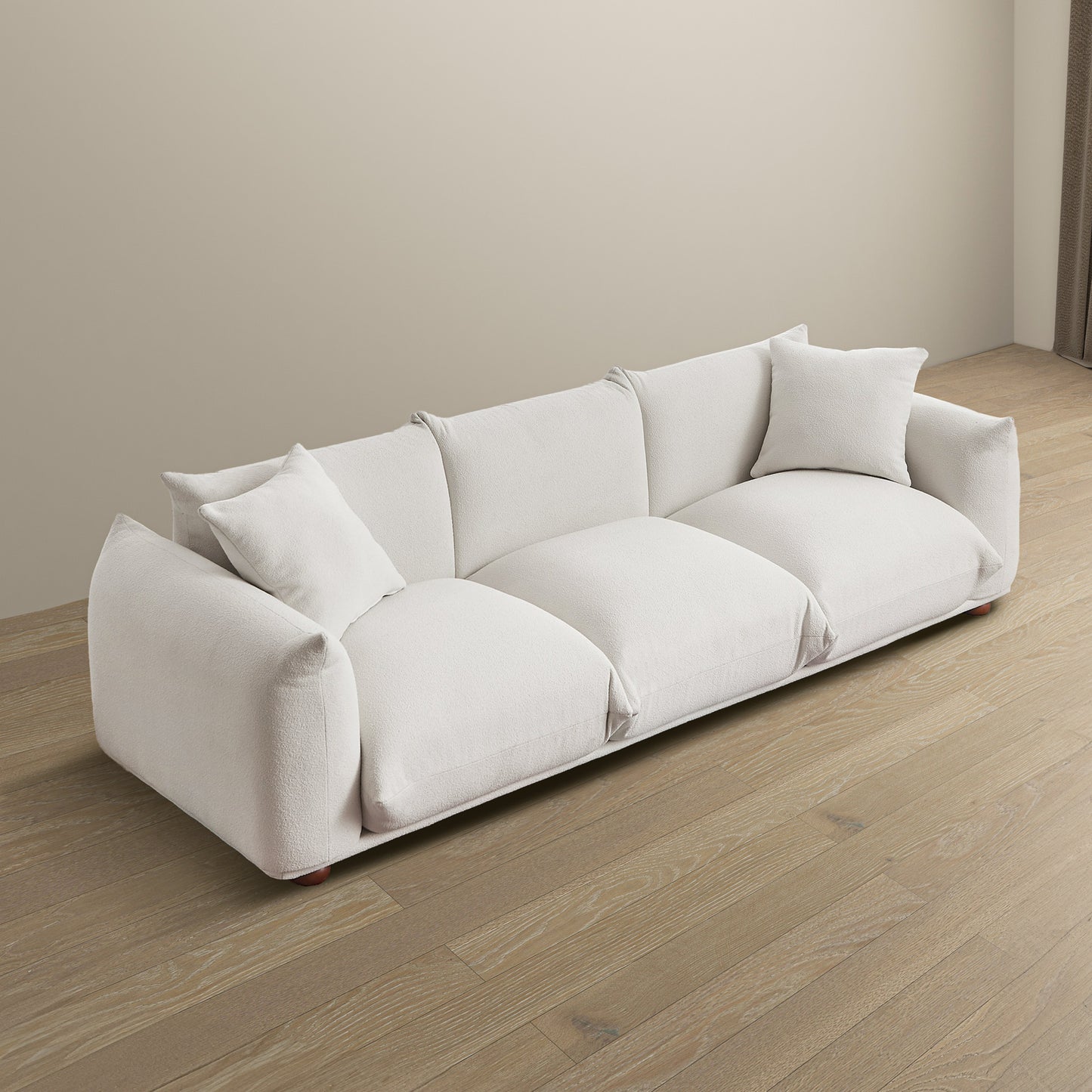 Plush white boucl fabric sofa with modern design and accent pillows