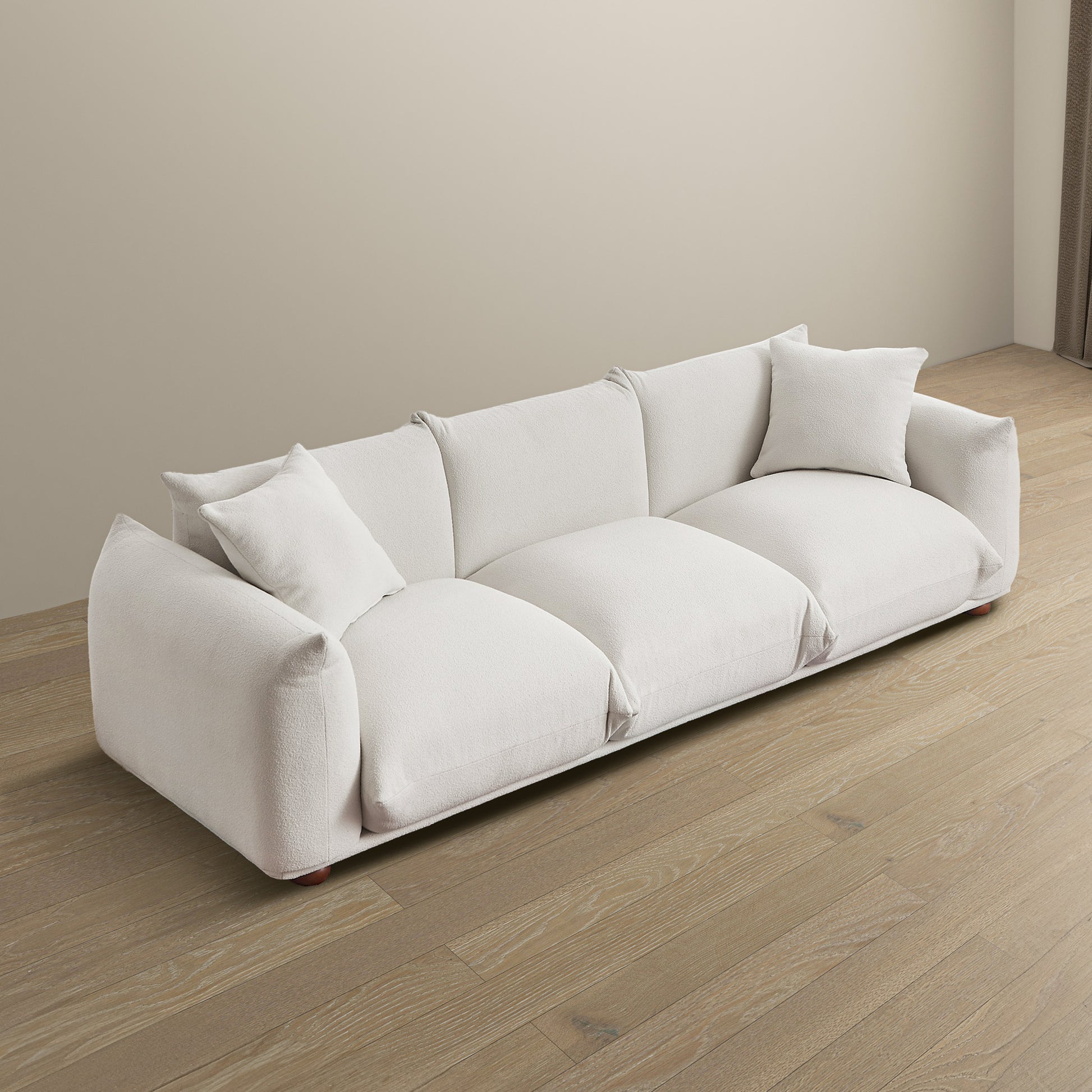 Plush white boucl fabric sofa with modern design and accent pillows