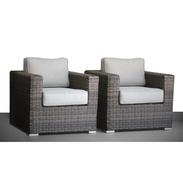Pair of grey rattan armchairs with cream cushions