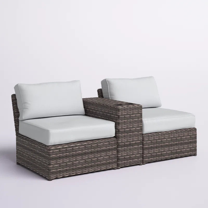 Gray wicker sectional sofa with white cushions and builtin side table