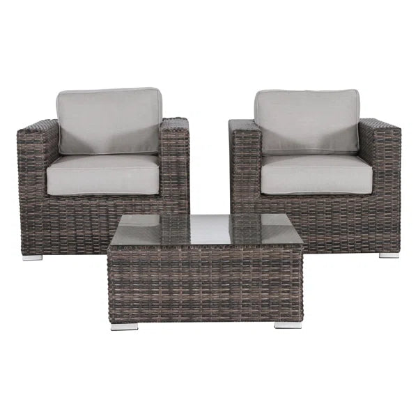 Brown wicker patio chairs and coffee table with glass top