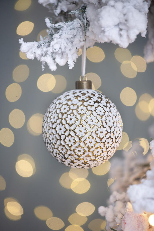 White floral patterned Christmas ornament with gold accents