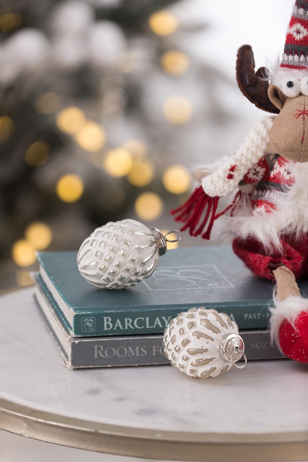 Textured white glass Christmas ornament resembling a pinecone with silver accents
