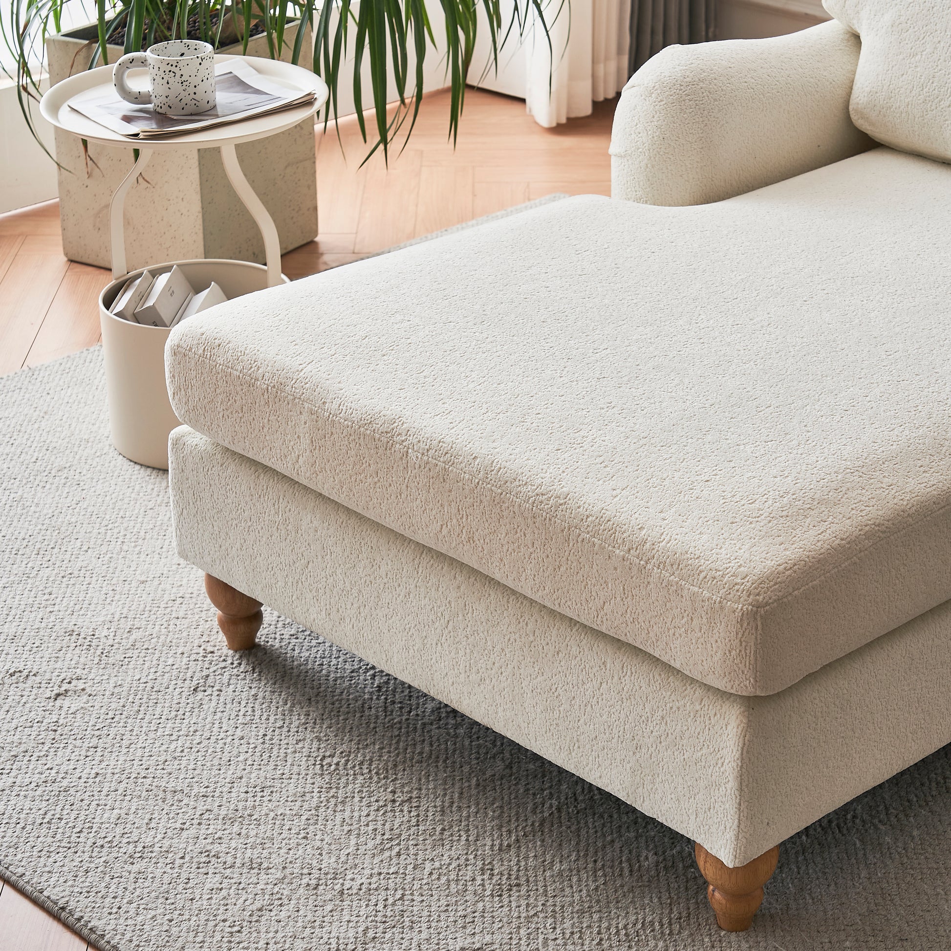 Cream boucle chaise lounge with wooden legs