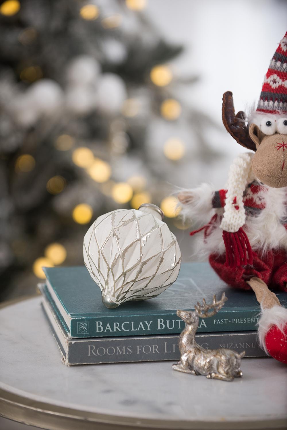 Ornate white glass Christmas ornament with silver etching