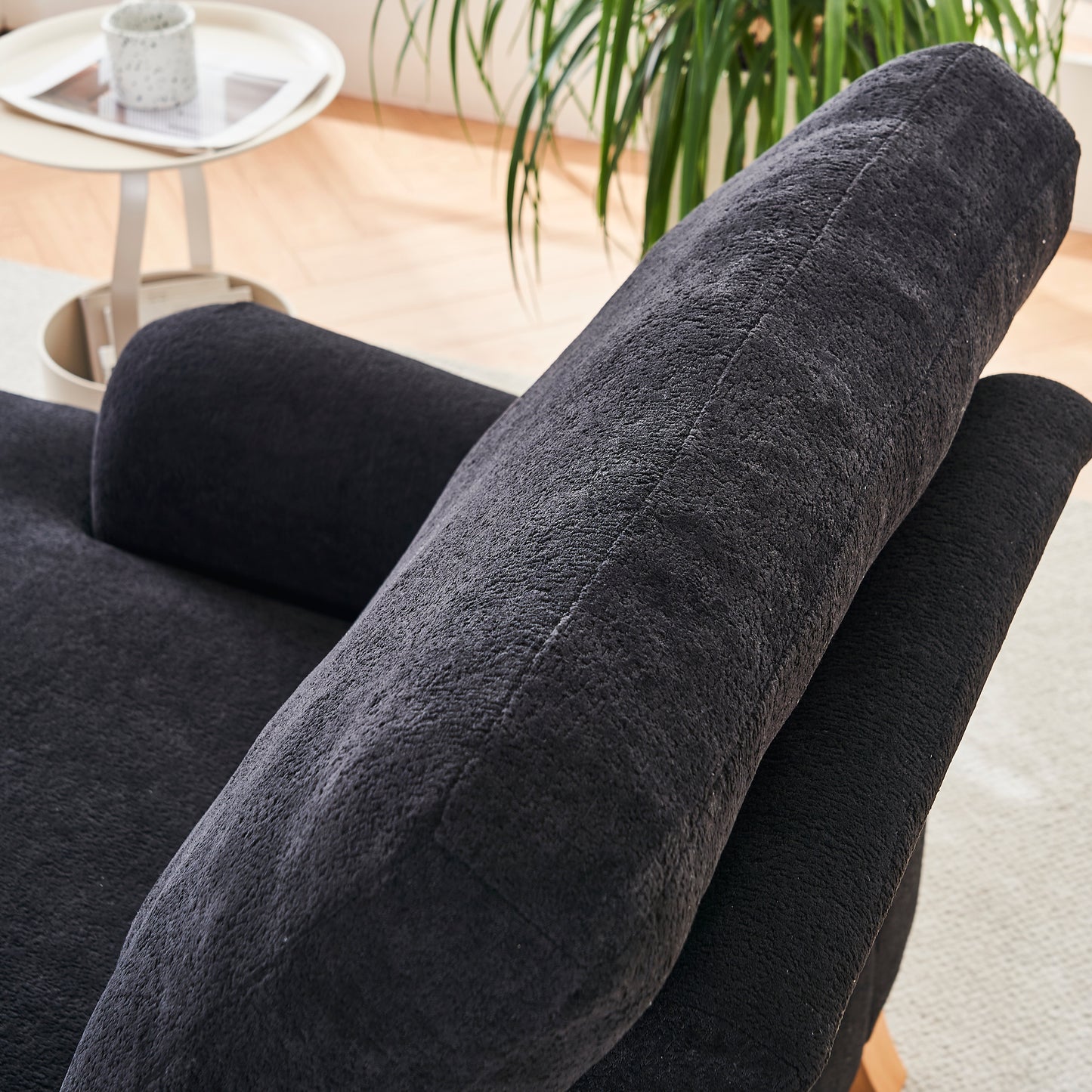 Closeup of a plush black throw pillow