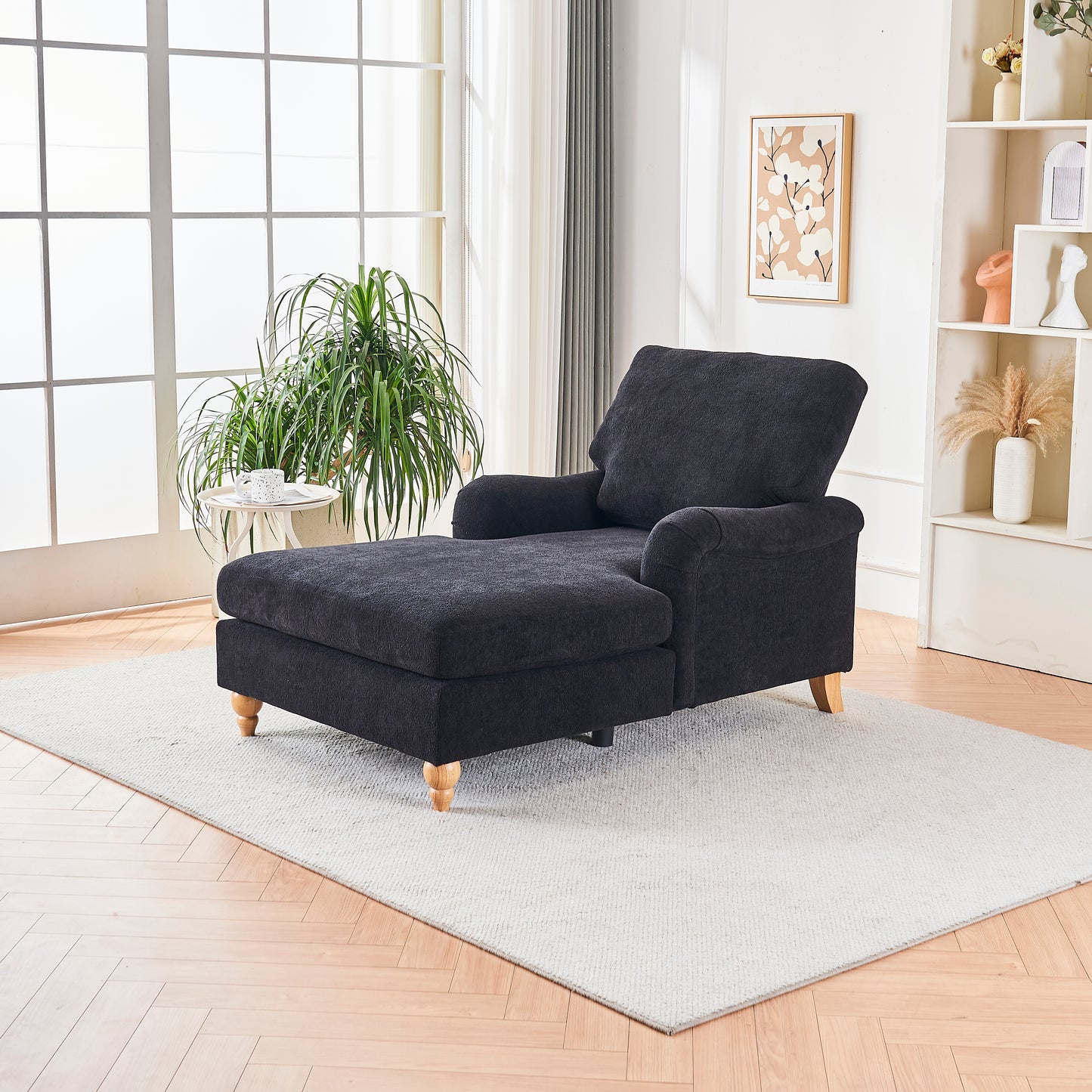 Dark gray fabric chaise lounge with plush cushions and wooden legs
