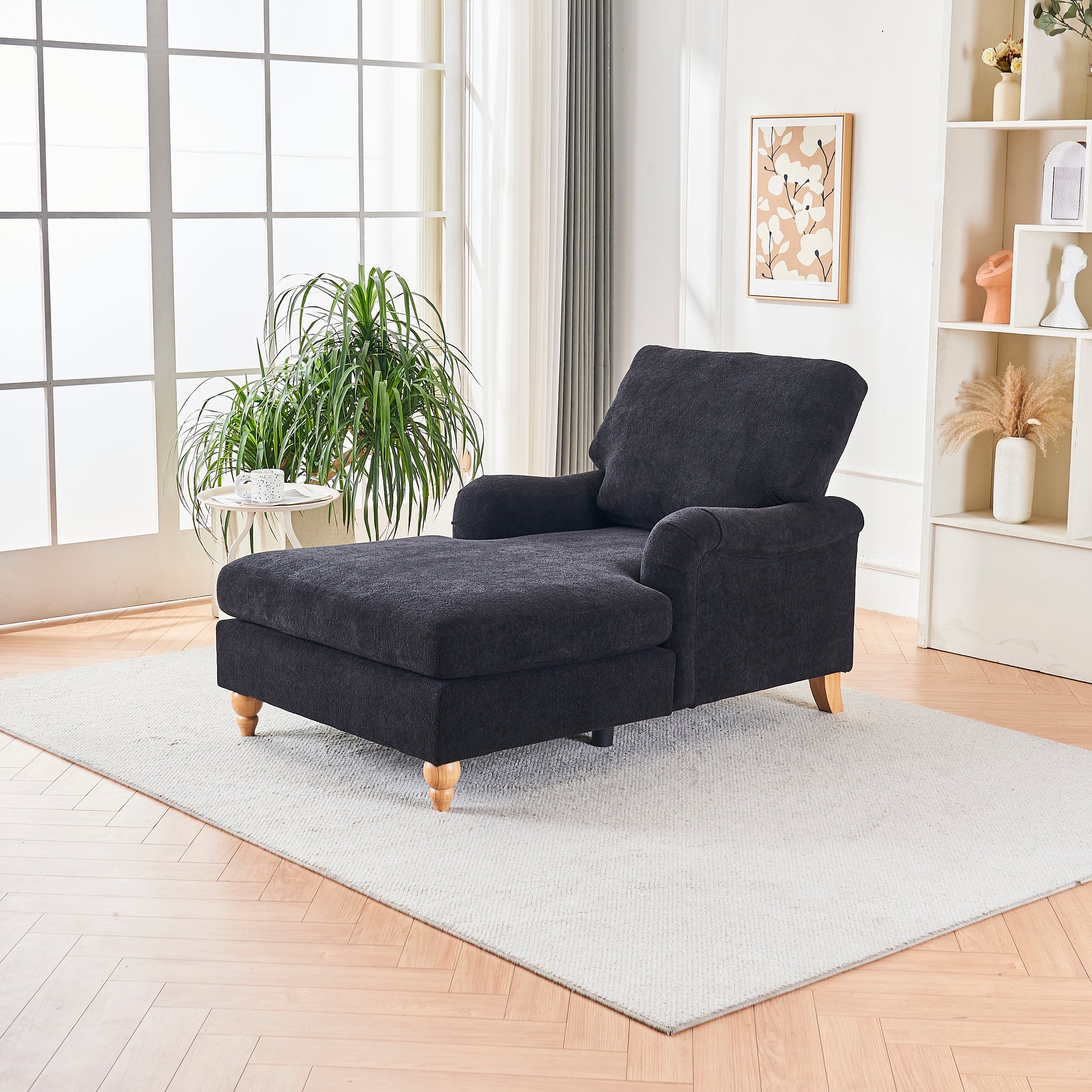 Dark gray fabric chaise lounge with plush cushions and wooden legs