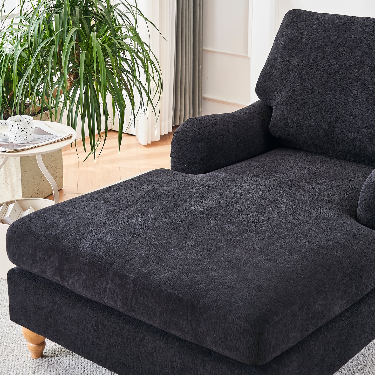 Dark gray plush sofa chaise lounge with plush fabric and wooden feet