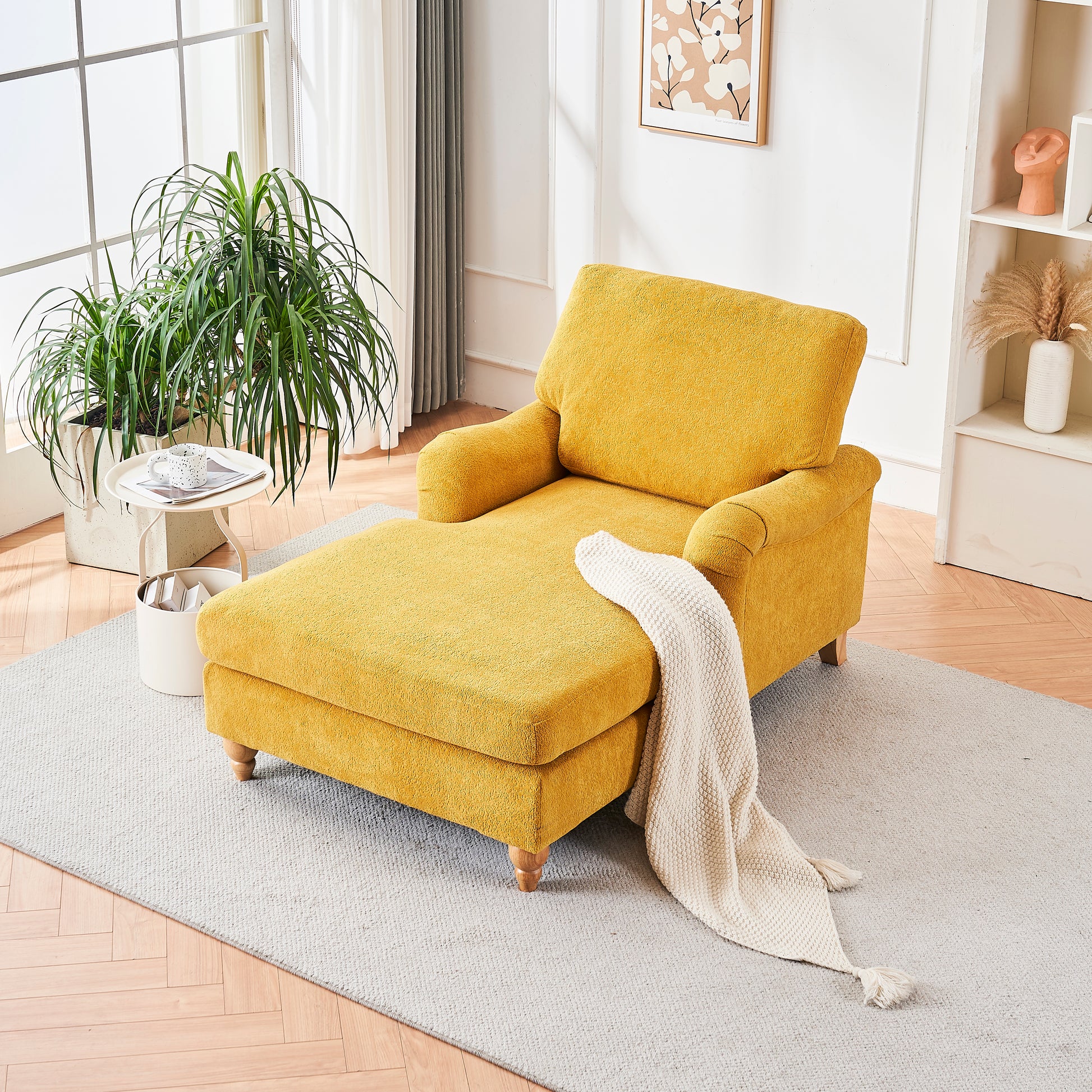 Plush yellow chaise lounge with a reclined ottoman and cream throw