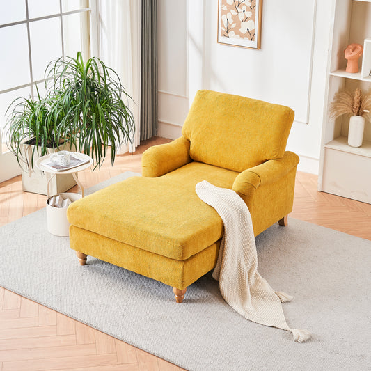 Plush yellow chaise lounge with a reclined ottoman and cream throw