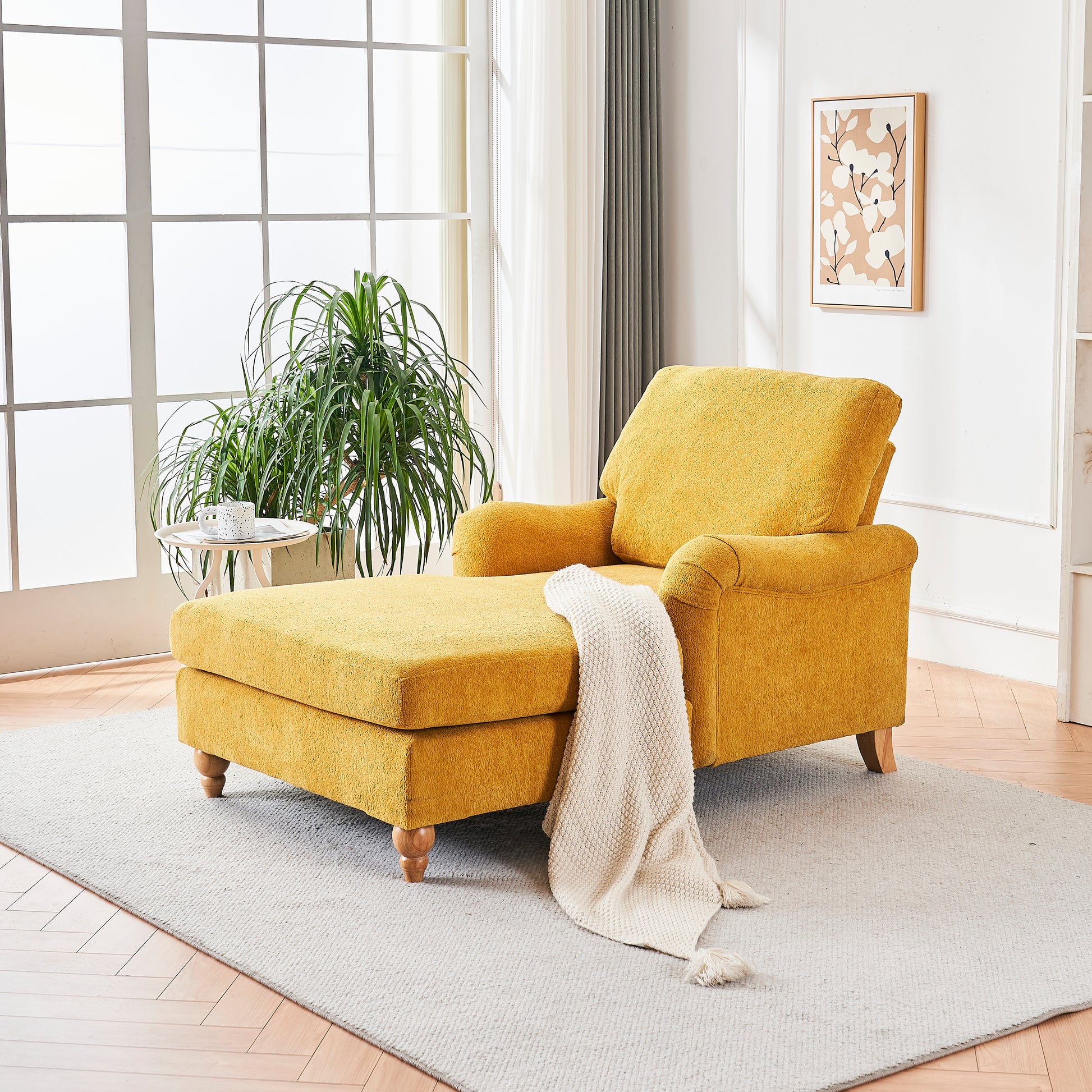Yellow upholstered chaise lounge with ottoman and cream blanket
