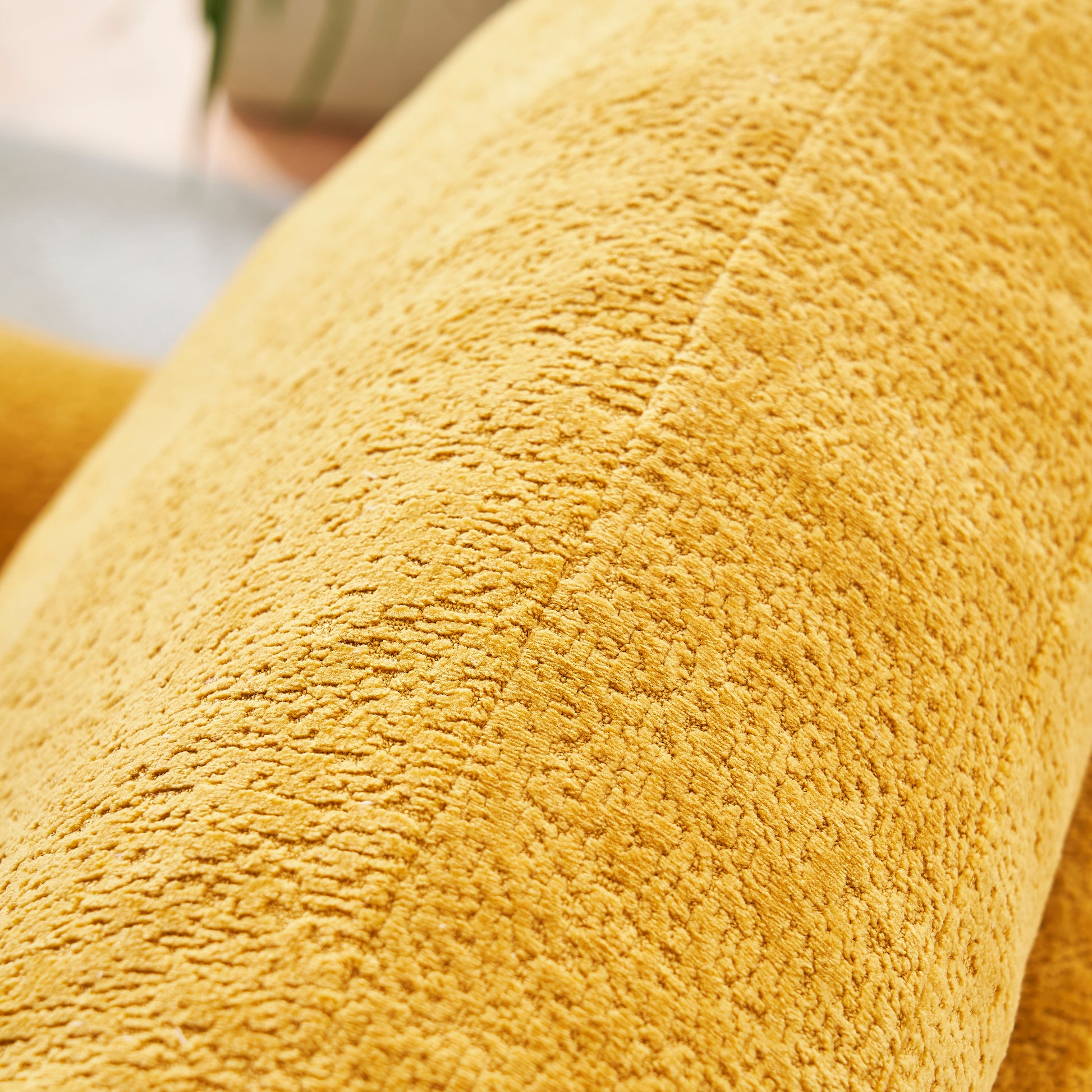 Closeup texture of a mustard yellow chenille throw blanket