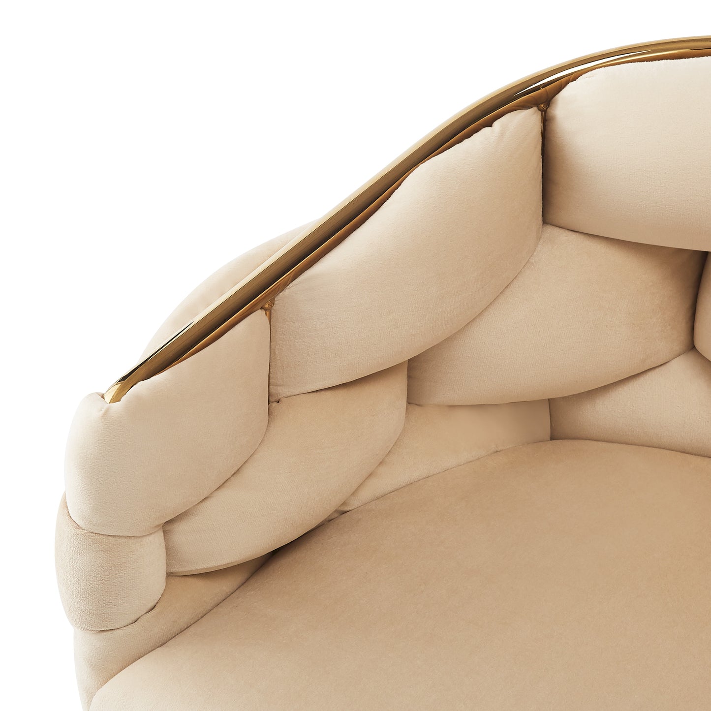 Closeup of a plush cream velvet armchair with gold trim detail