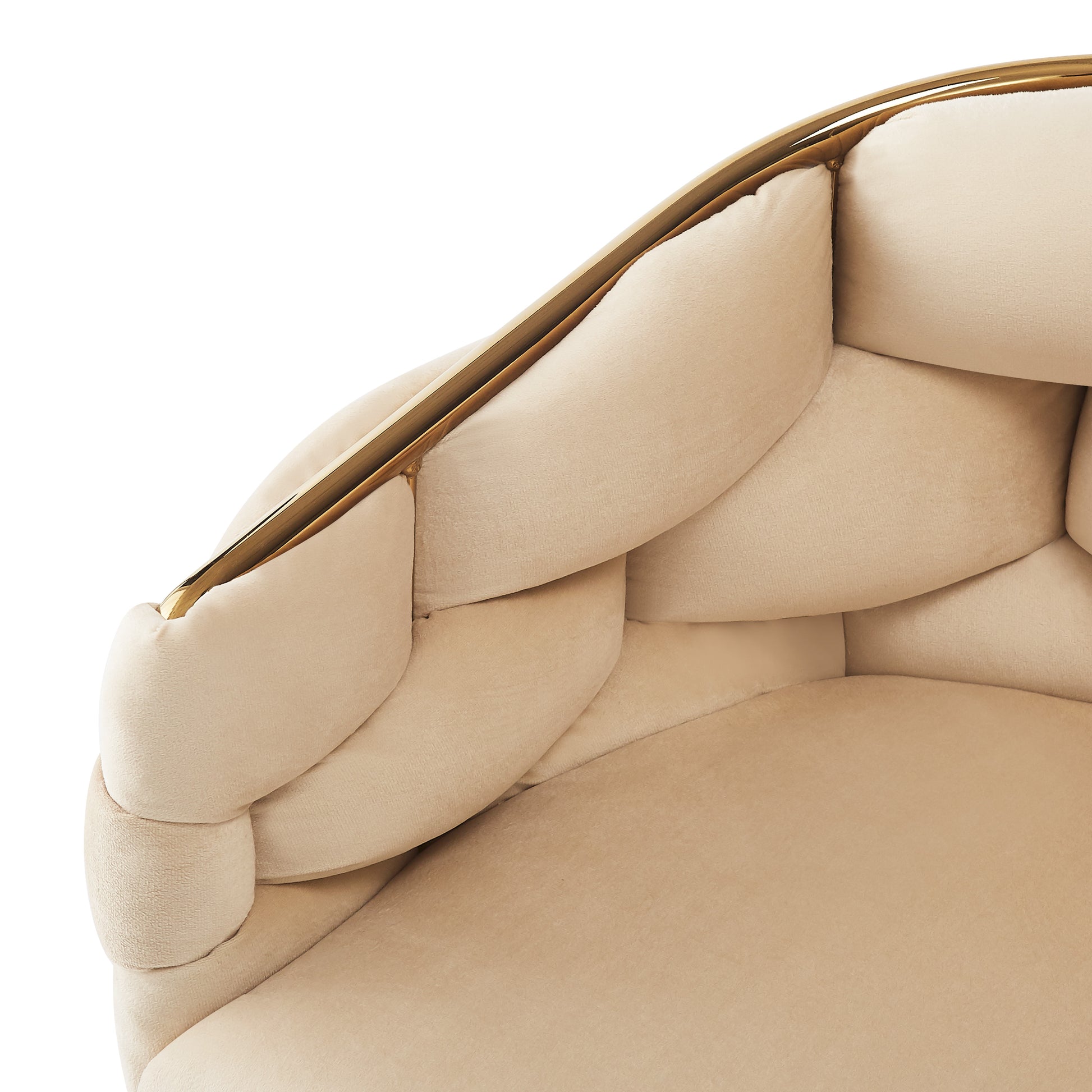 Closeup of a plush cream velvet armchair with gold trim detail