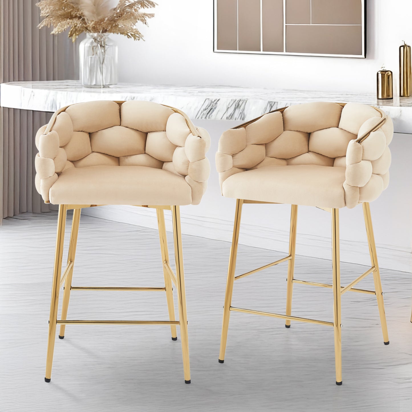 Plush beige velvet tufted bar stool with gold legs and curved armrests