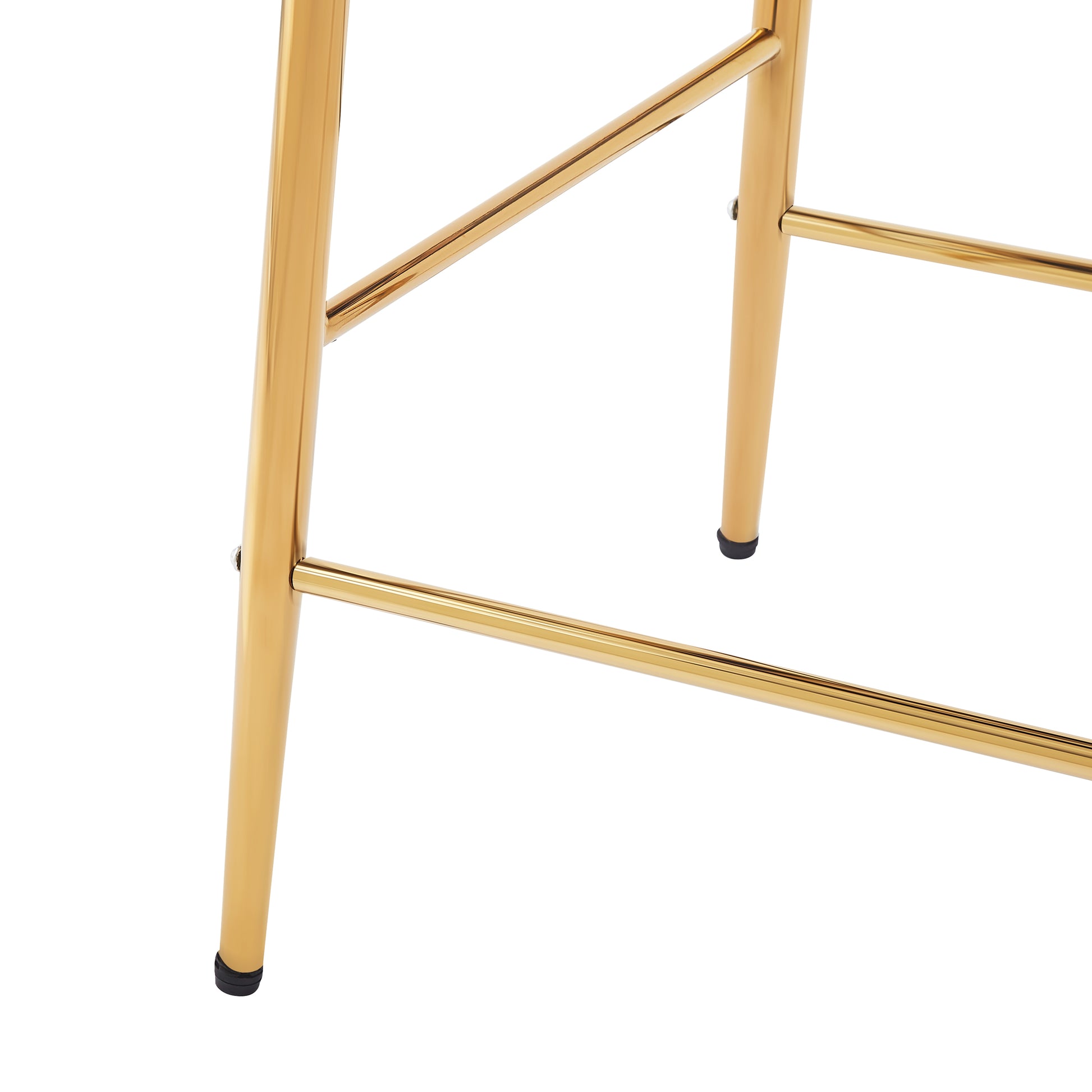 Close up of gold metal bar stool legs with black foot caps