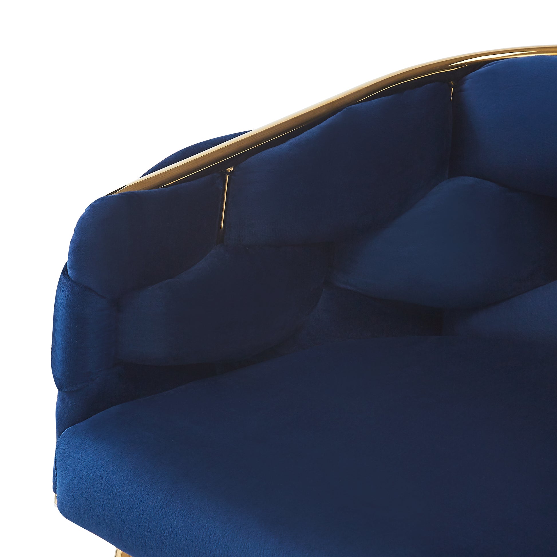 Deep navy velvet chair with tufted back and polished gold frame detail