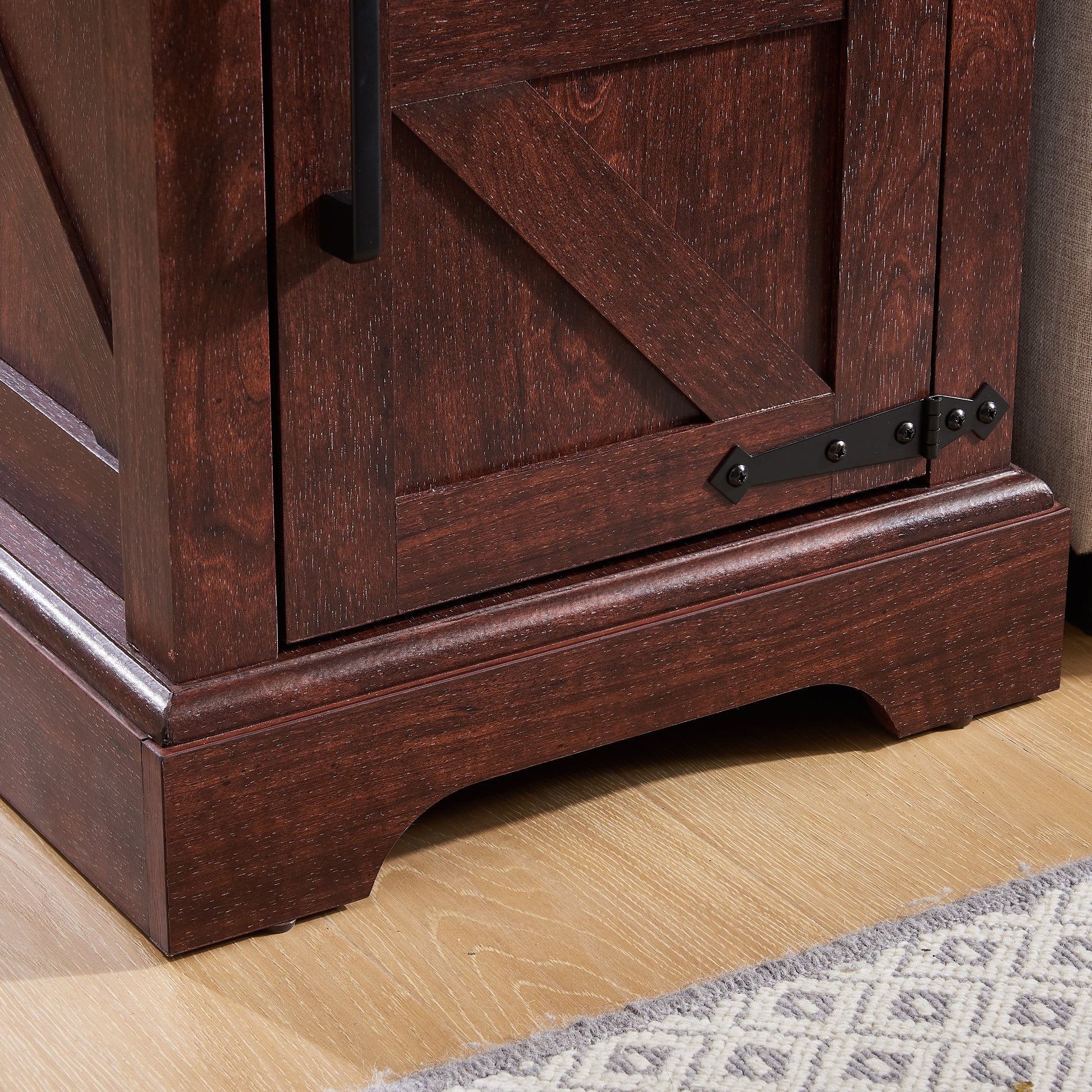 Dark brown wooden barn door cabinet detail with black hardware