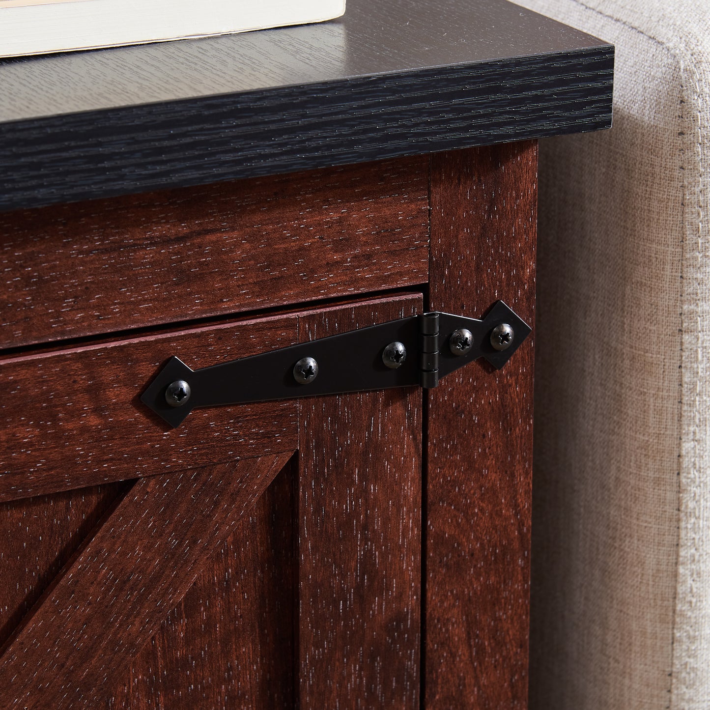 Dark wood nightstand detail with black barn door hinge