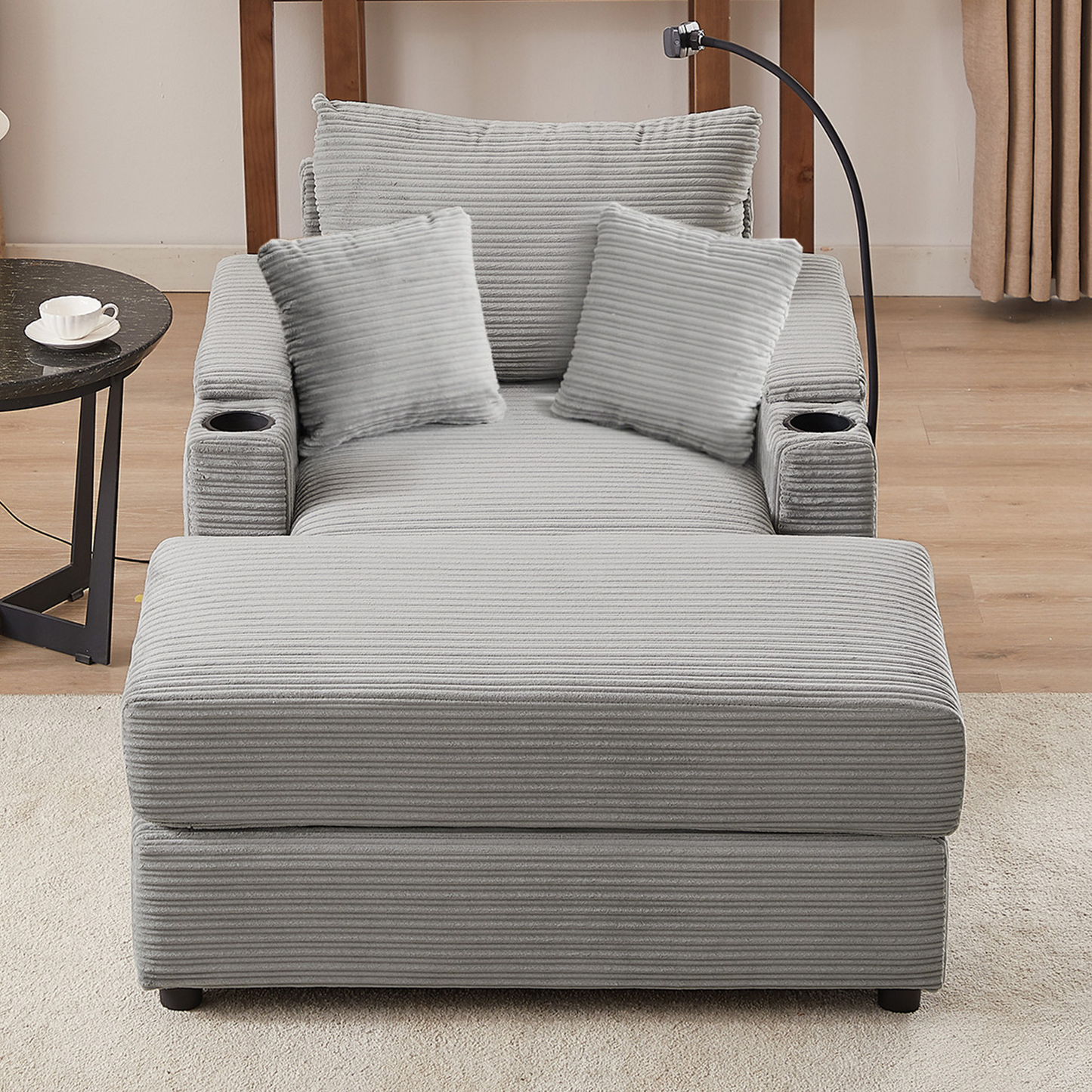 Gray corduroy chaise lounge with two pillows and cup holders