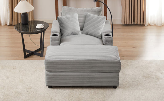 Gray corduroy recliner with plush pillows and builtin cup holders