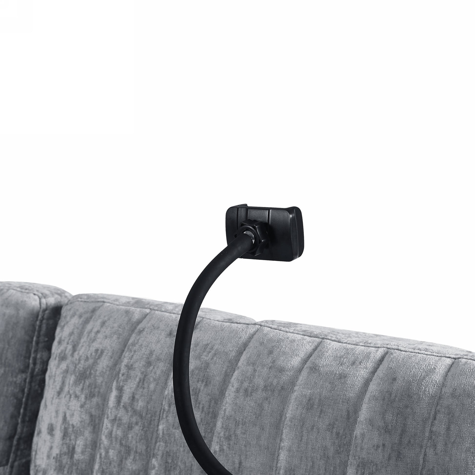 Black flexible gooseneck phone holder clamped to plush grey headboard