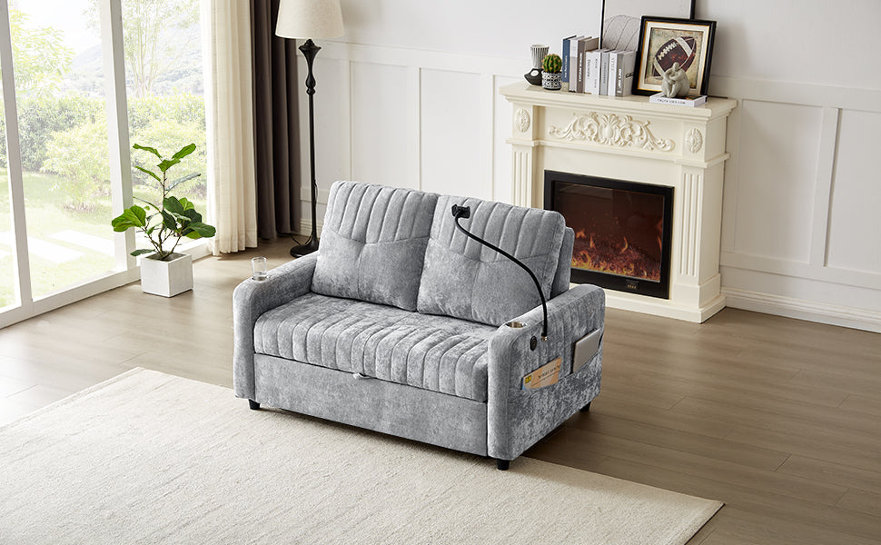 Grey velvet loveseat with tufted cushions and builtin phone holder