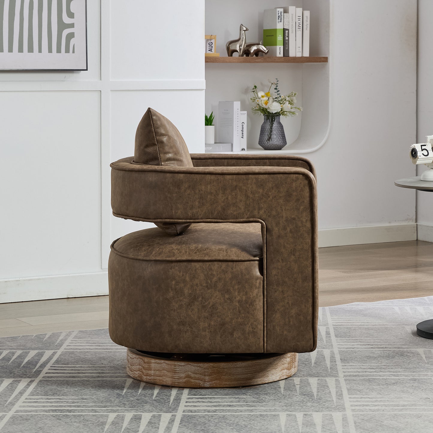 Brown leather swivel accent chair with cushioned seat and back