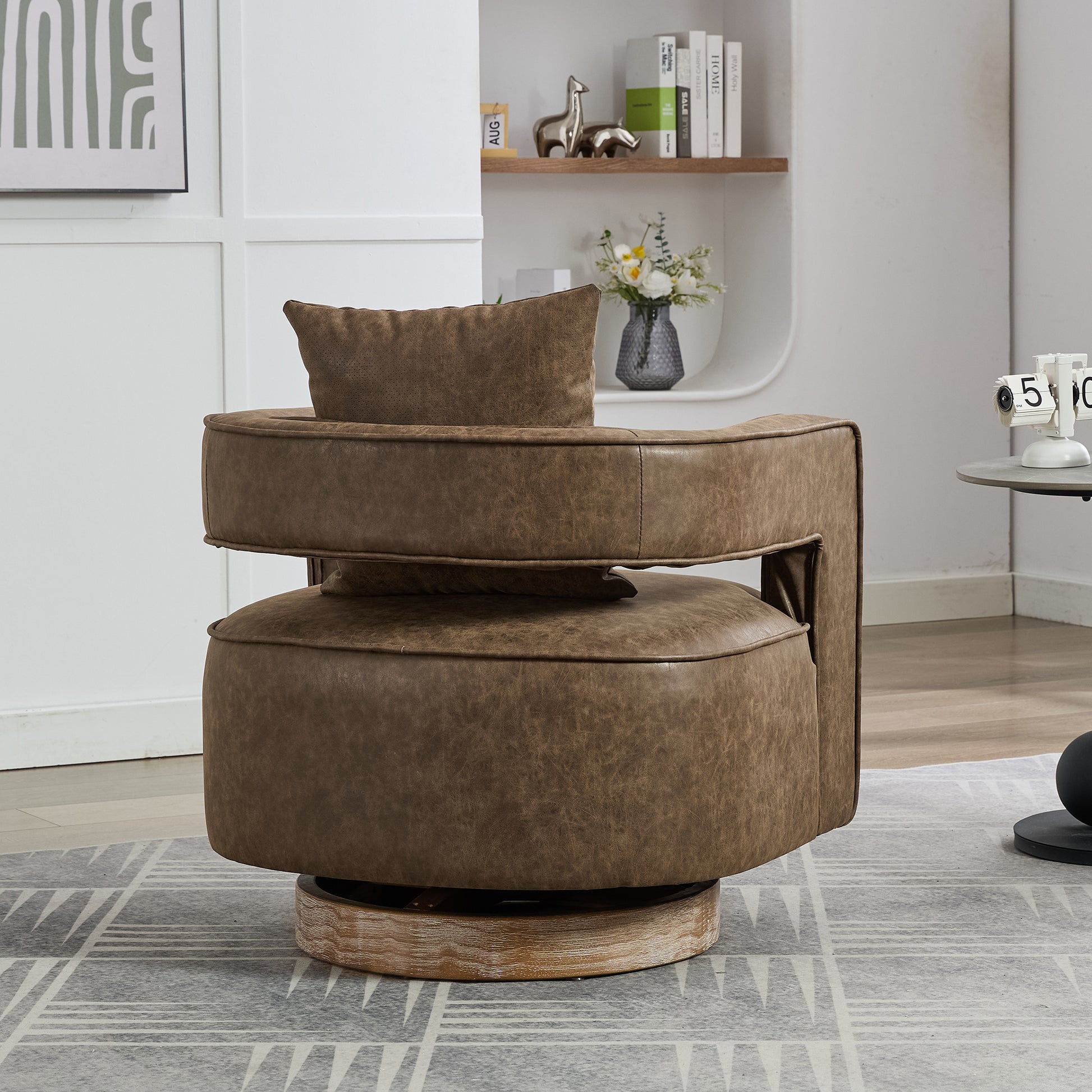 Brown faux leather swivel accent chair with plush pillow