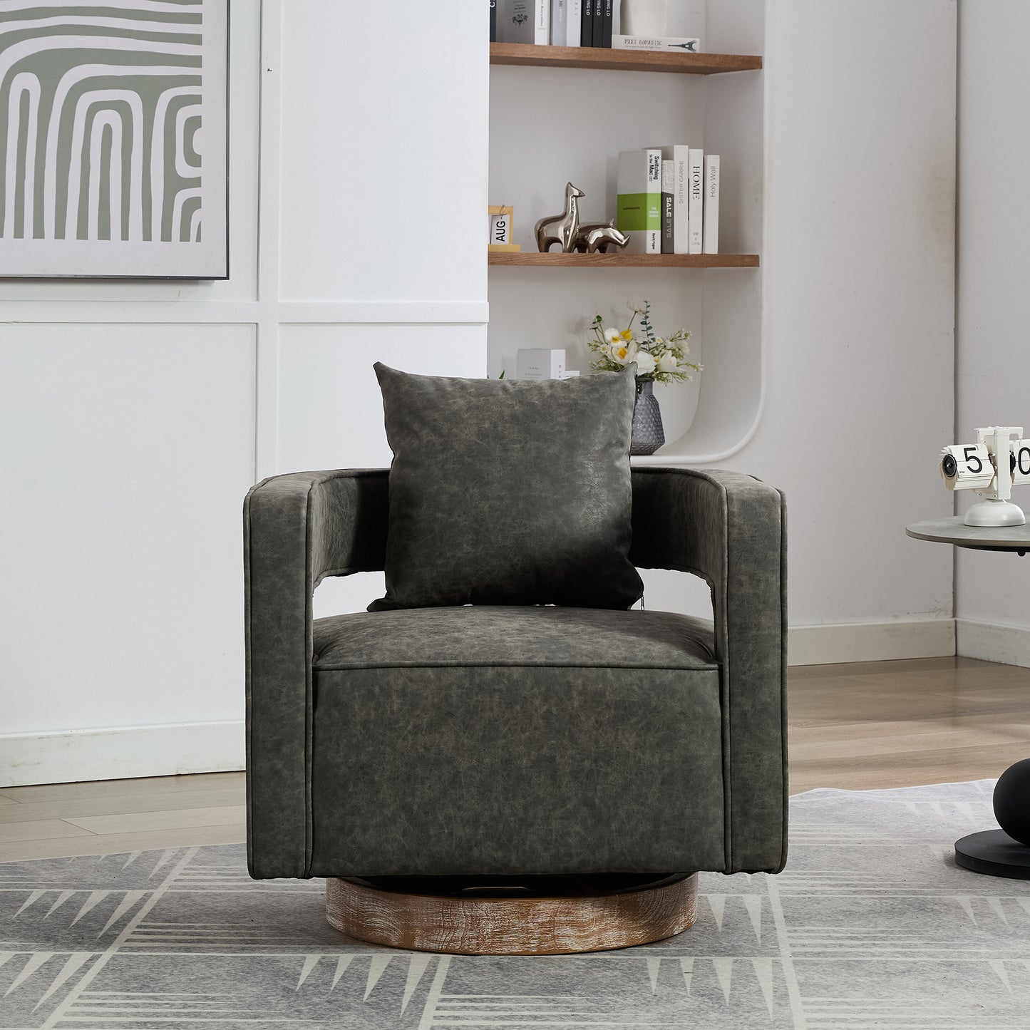 Dark grey faux leather swivel chair with a plush pillow and wooden base