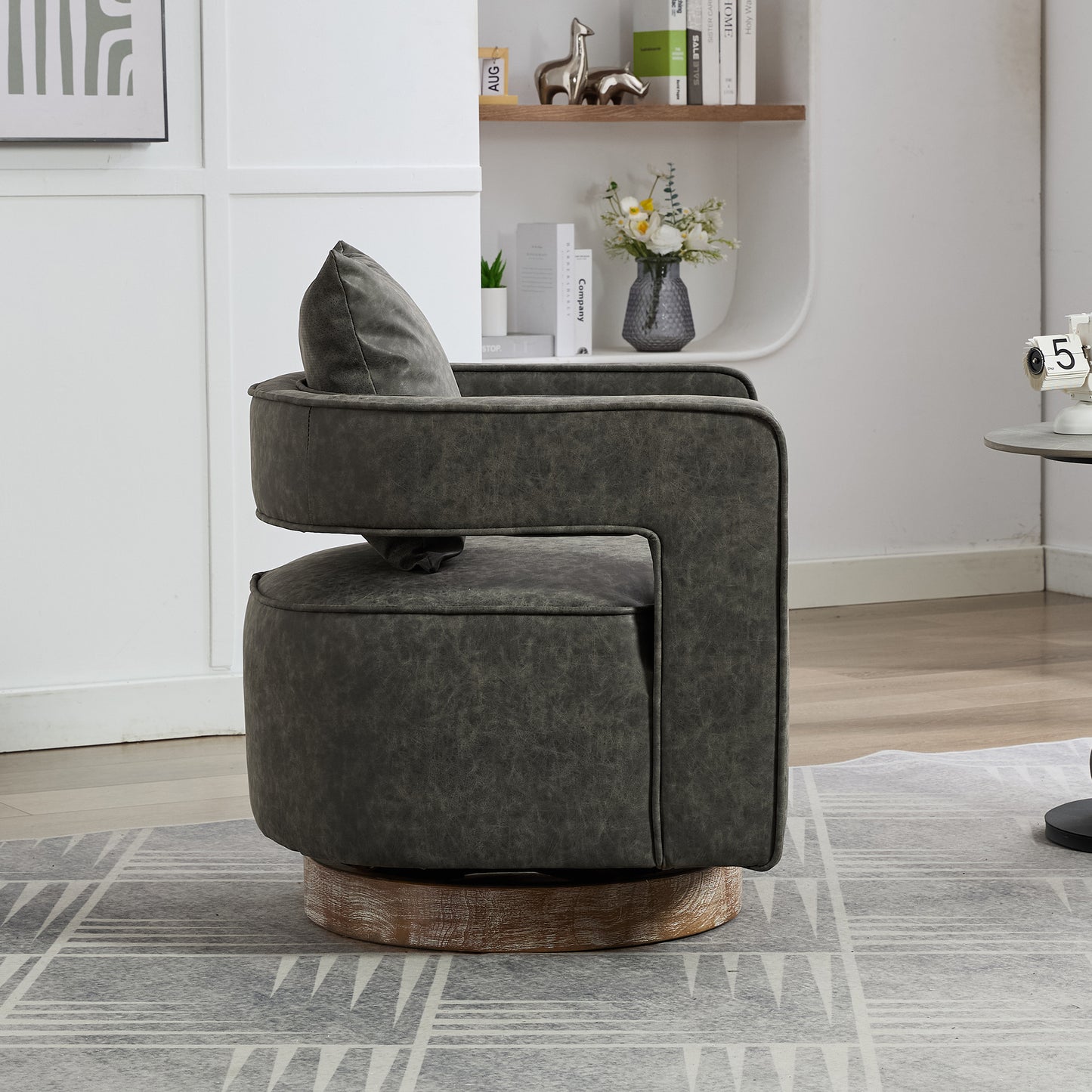 Dark grey swivel accent chair with distressed faux leather upholstery and a wooden base
