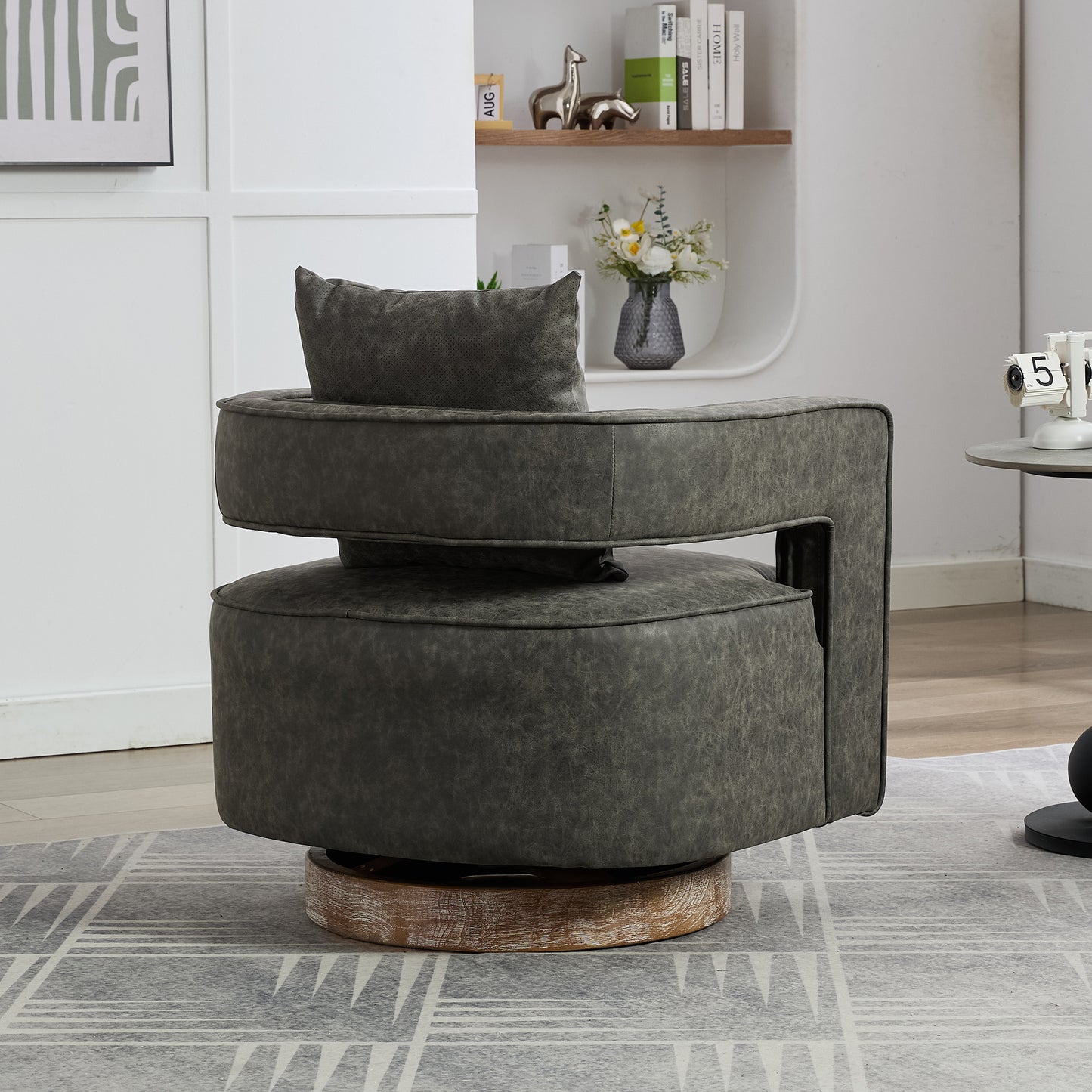 Dark grey faux leather swivel chair with plush cushion and wooden base