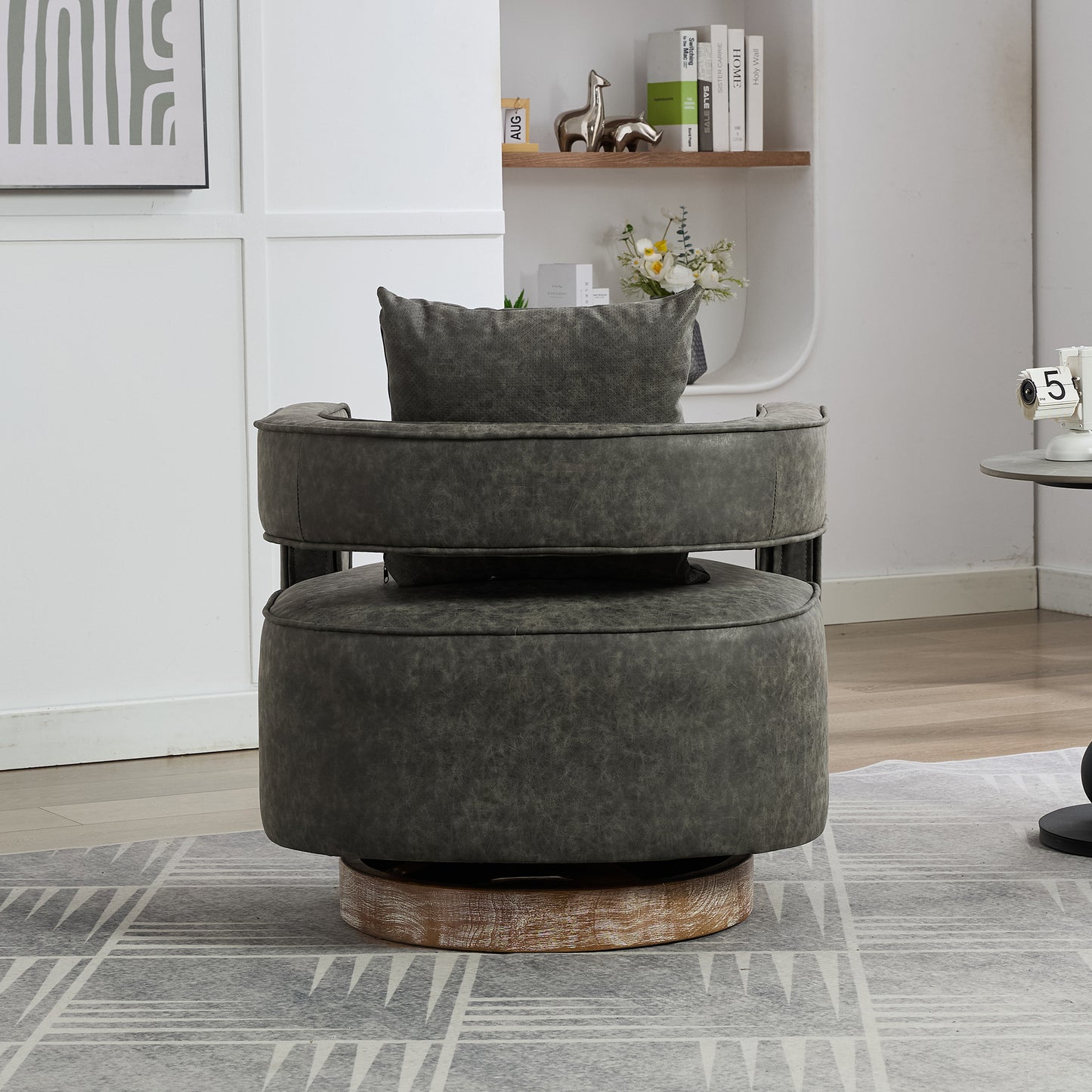 Dark gray swivel accent chair with distressed leather upholstery and a wooden base