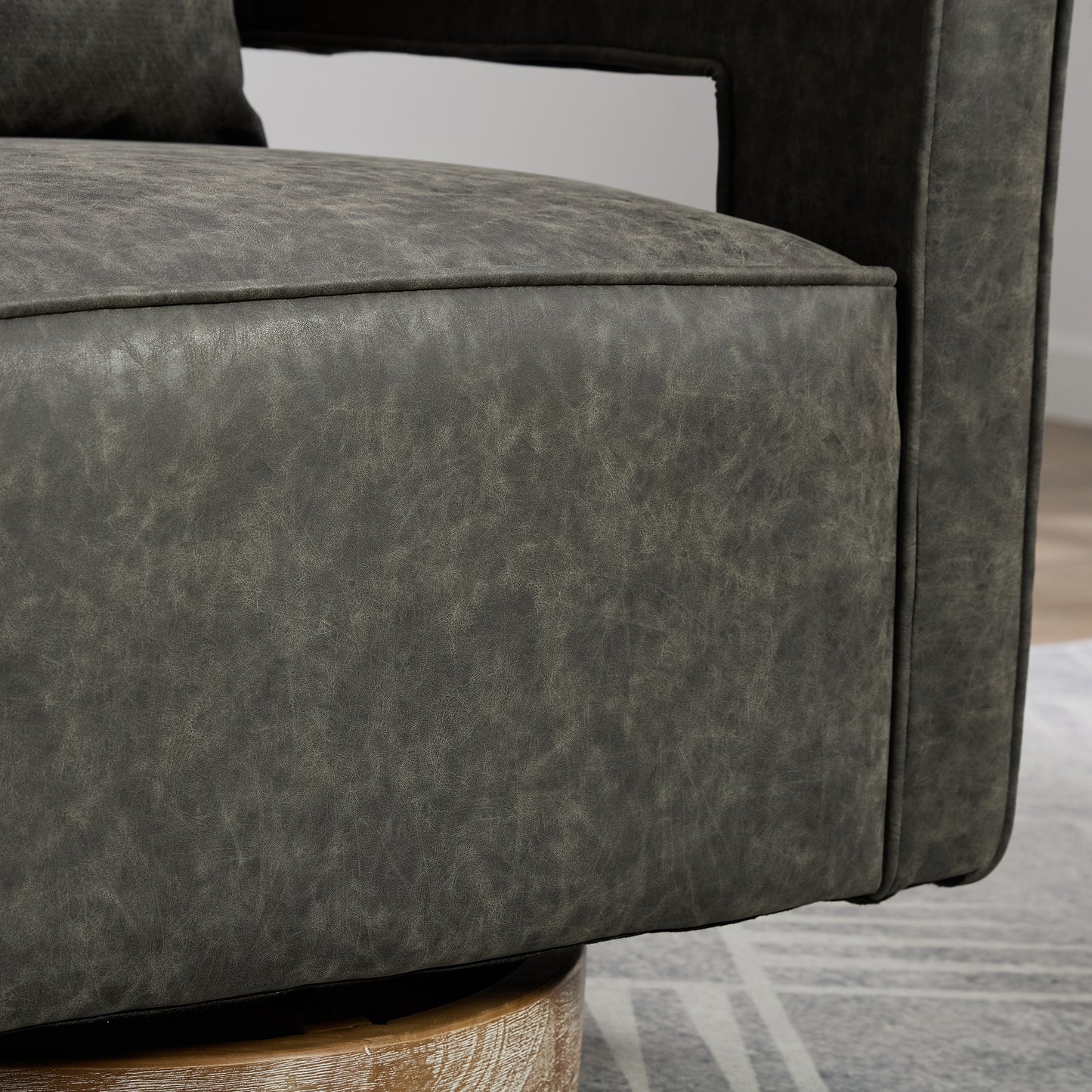 Closeup of textured charcoal grey faux leather armchair