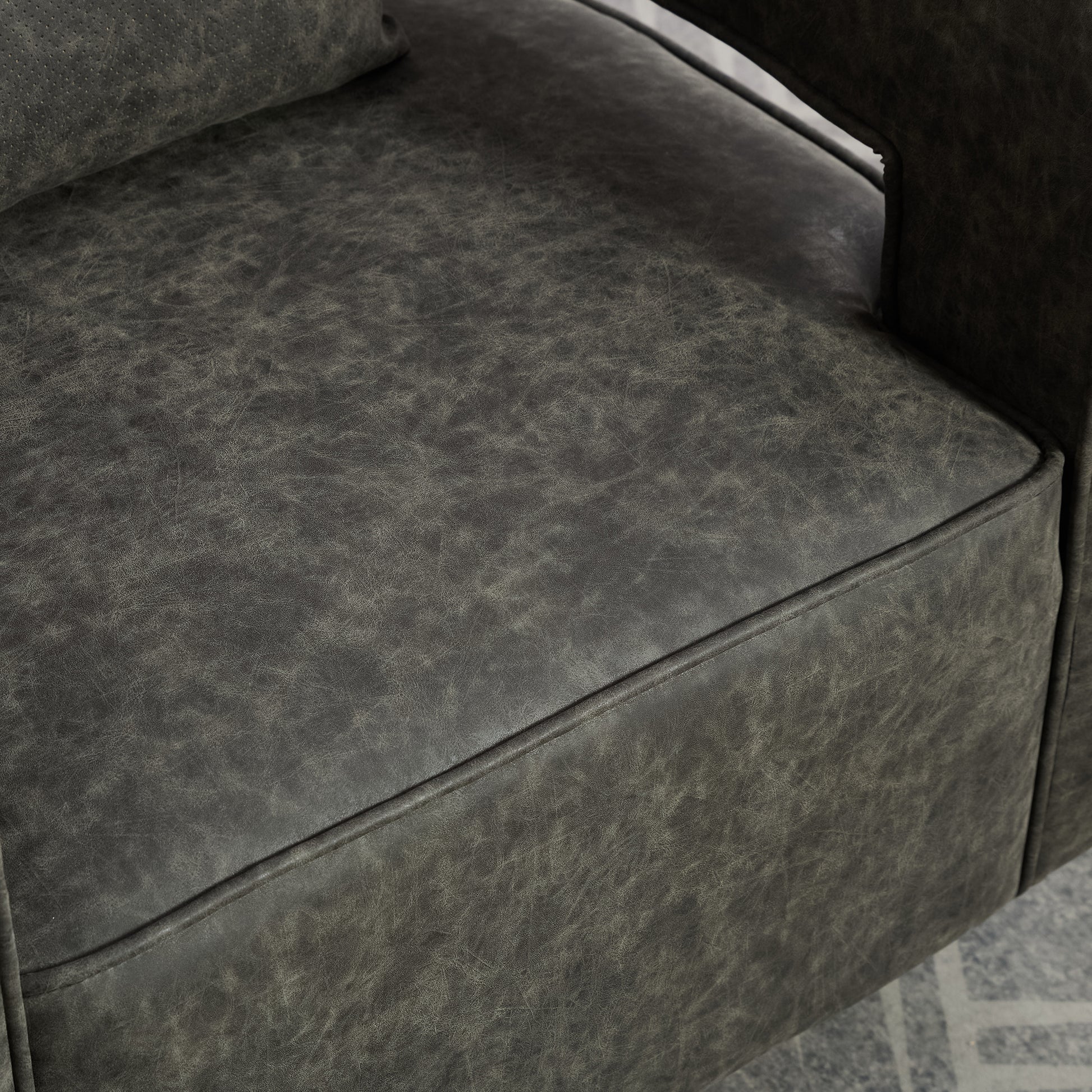 Closeup of distressed charcoal leather upholstery on a recliner