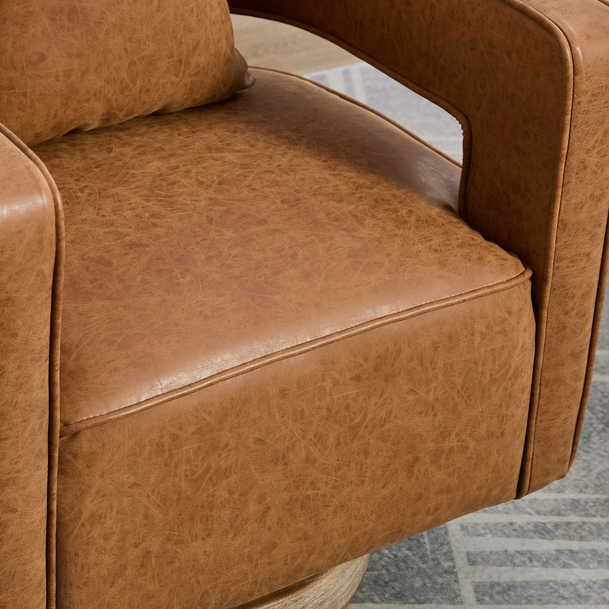 Tan distressed leather armchair seat detail