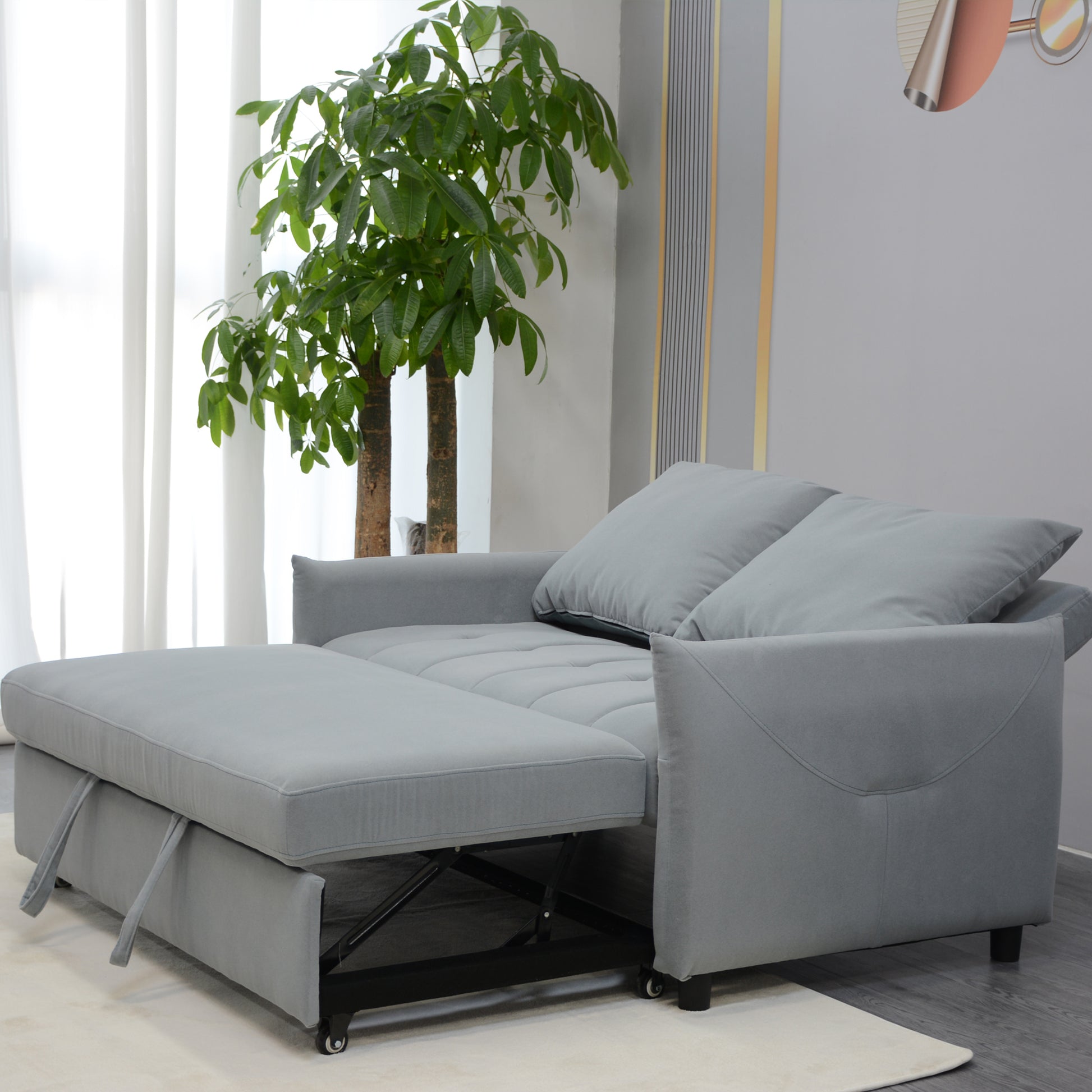 Grey fabric sofa bed with pullout mattress and plush cushions