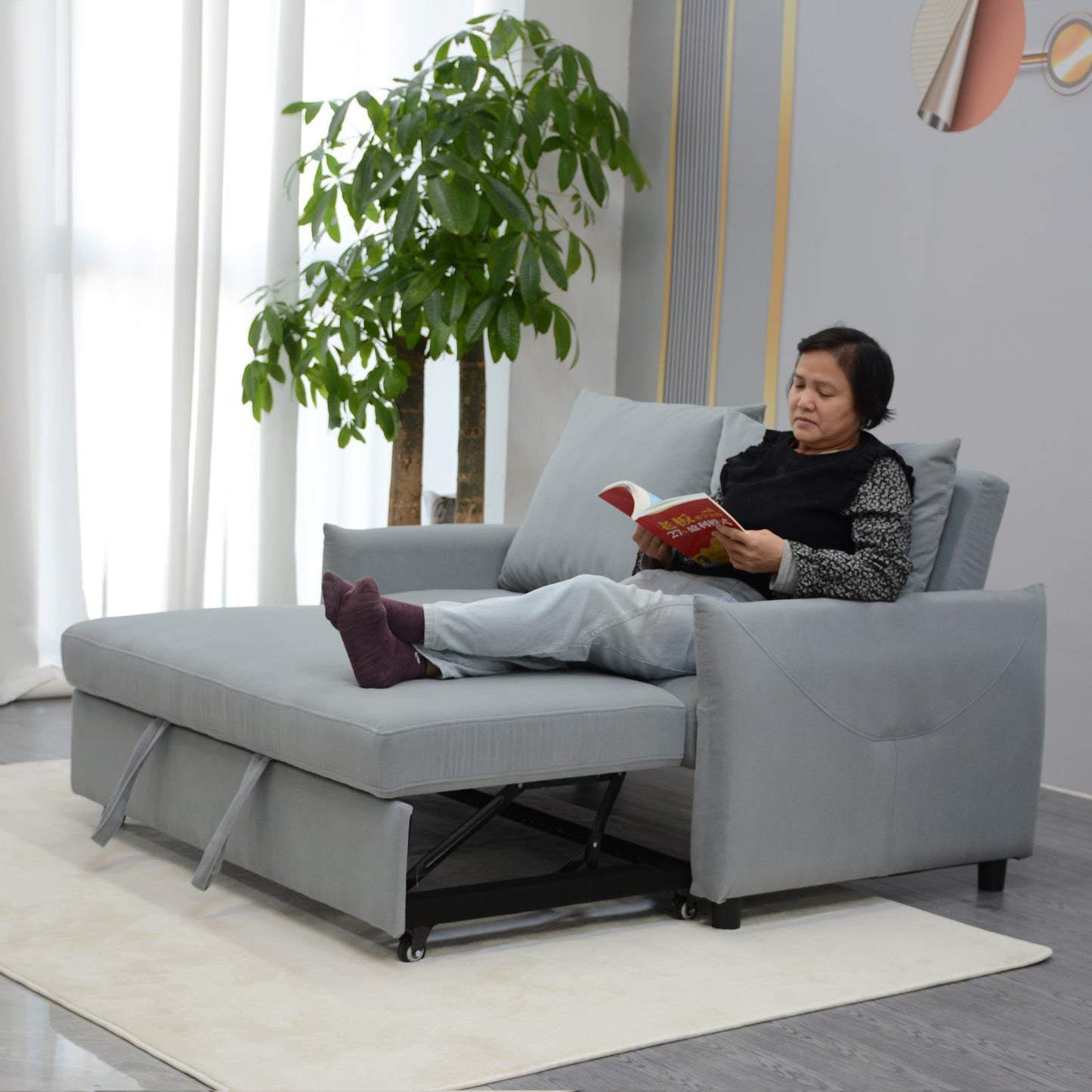 Gray fabric sofa bed with pullout mattress