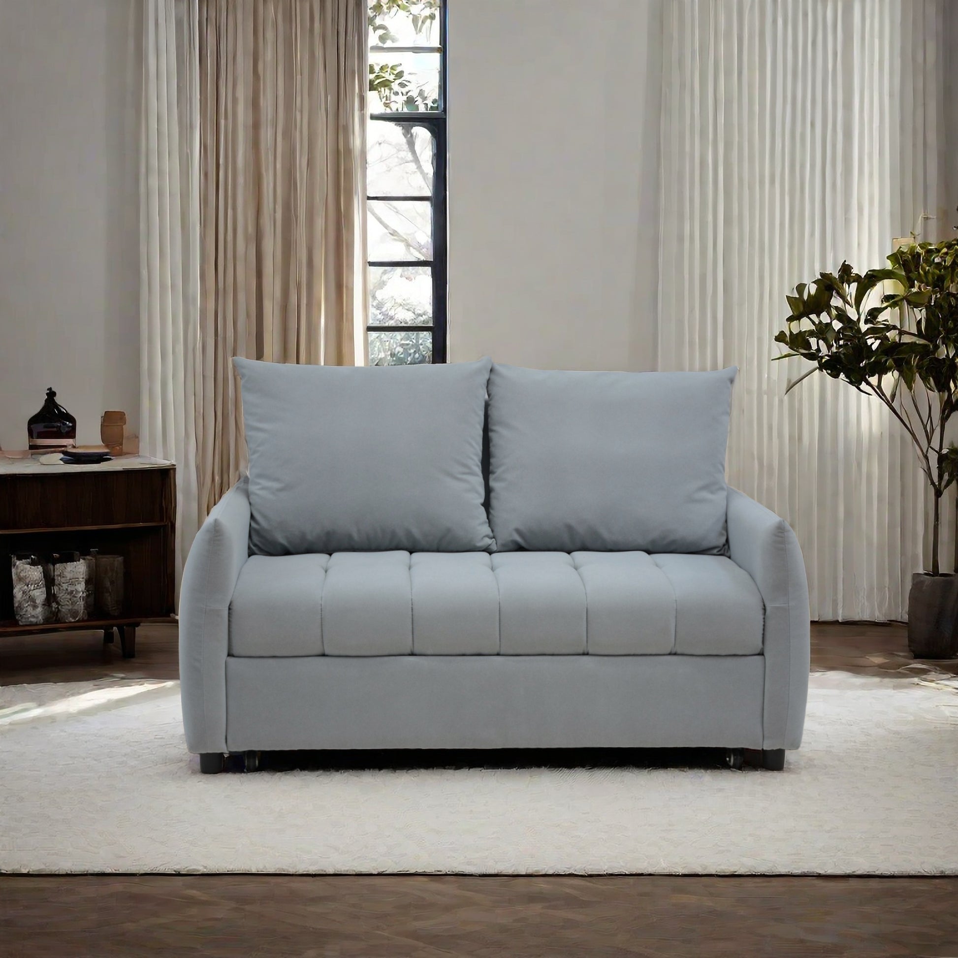 Light gray fabric sofa with tufted seat and plush back cushions