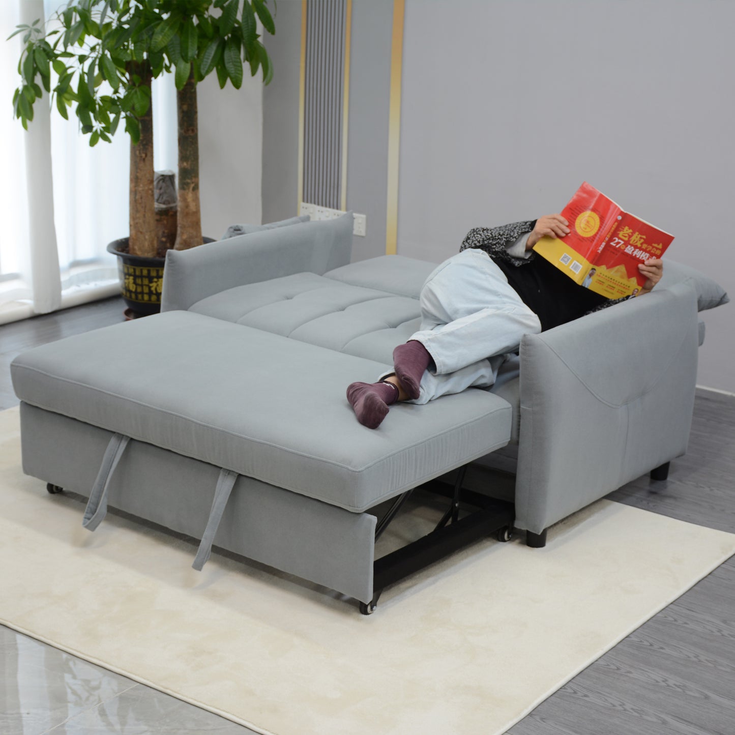 Grey fabric sofa bed with pullout mattress extension