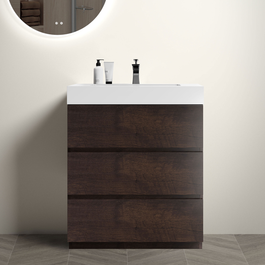 Dark wood bathroom vanity with white integrated sink and chrome faucet