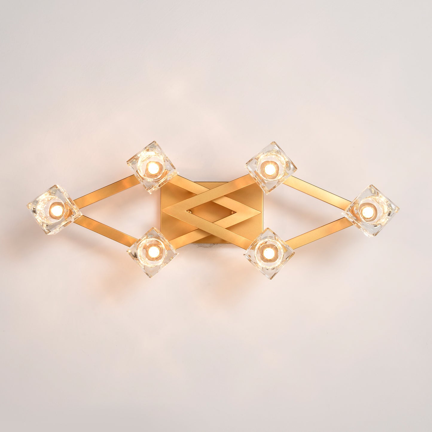 Modern gold wall sconce with diamondshaped crystal accents